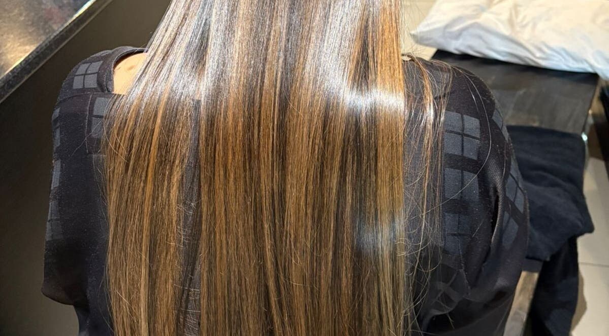 Sleek, straightened brunette hair at Gloss Lab, Cape Town, Western Cape, ZA, showcasing professional salon care.