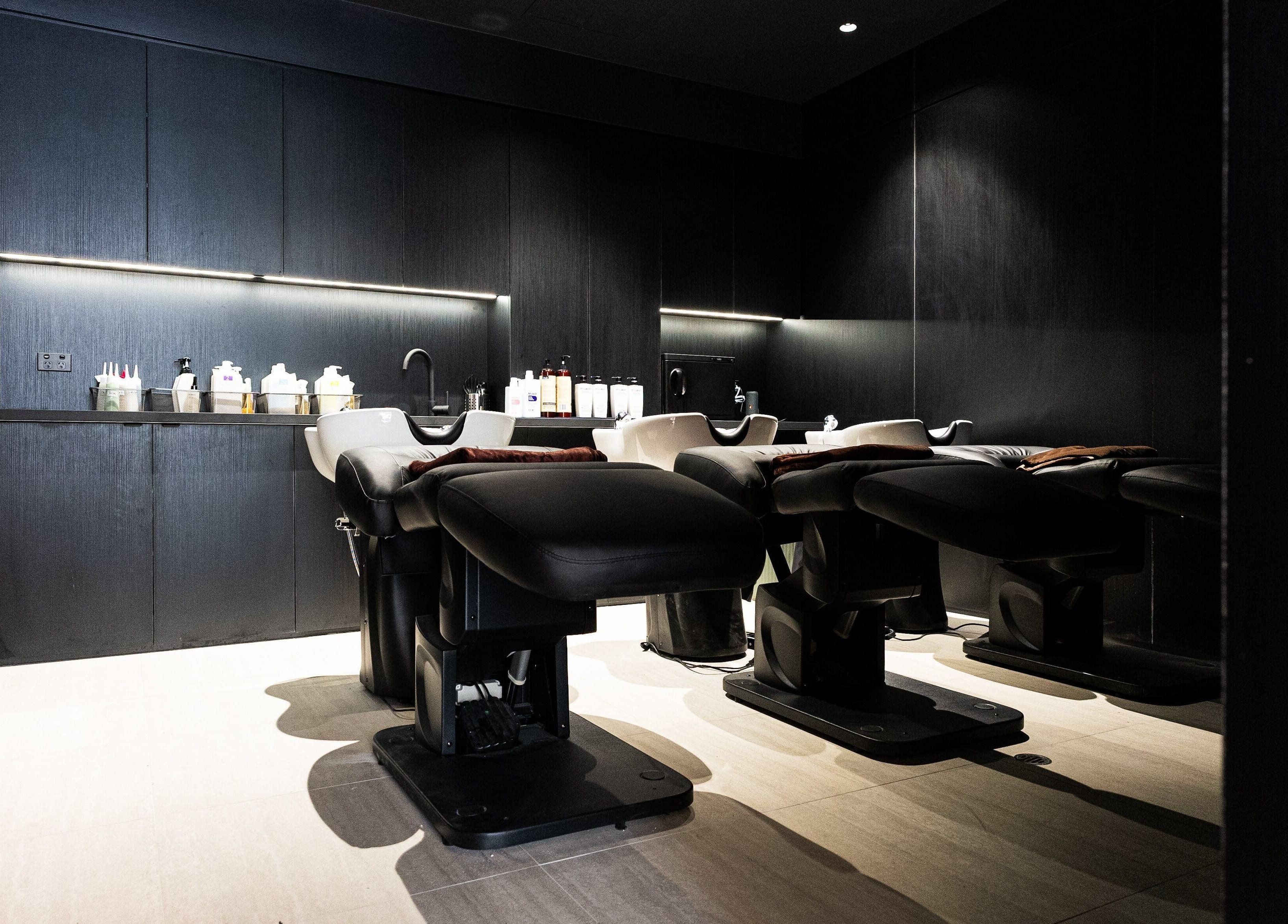 Luxurious washing area at Yasu in Perth, Western Australia, AU with modern chairs and sleek design.