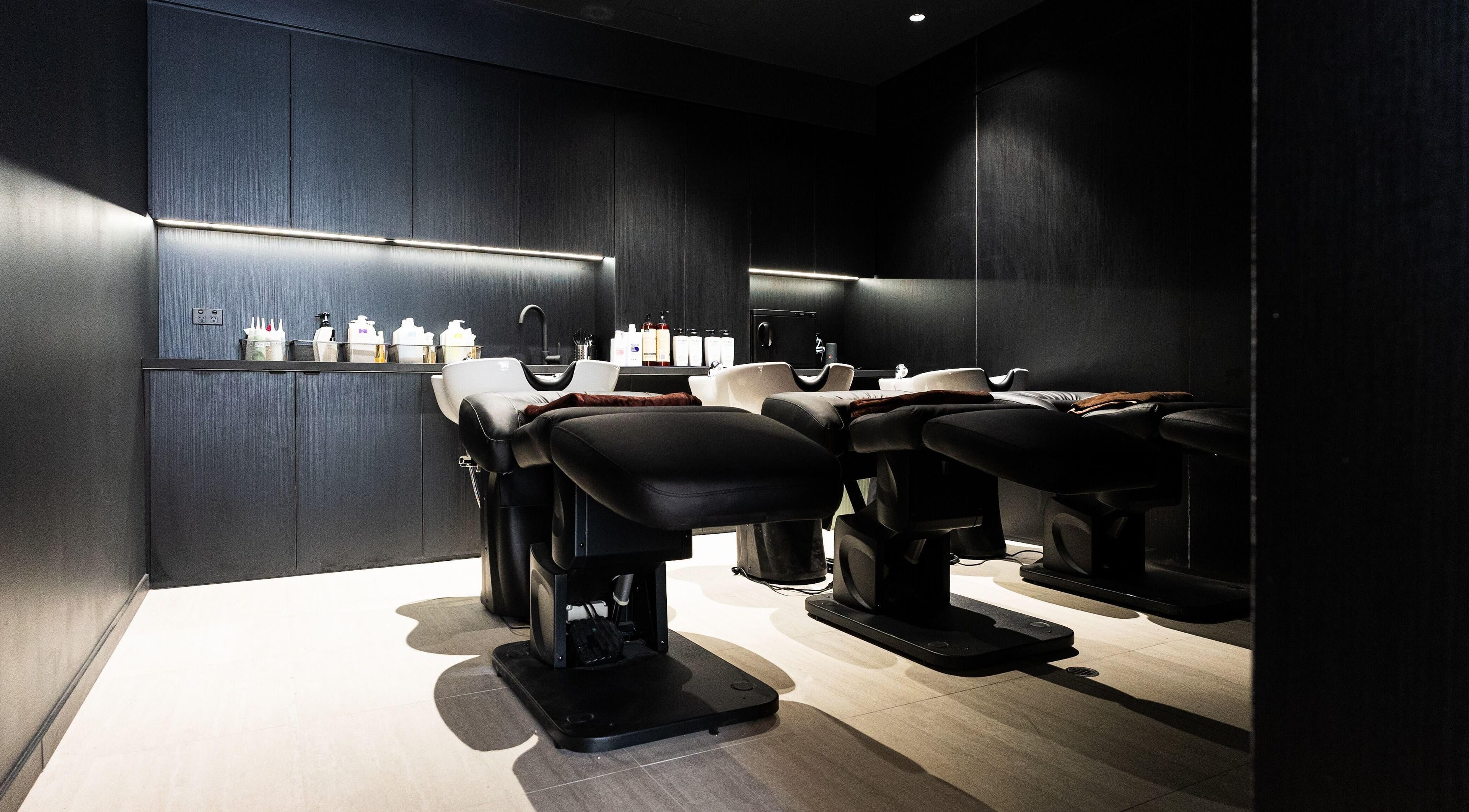 Luxurious washing area at Yasu in Perth, Western Australia, AU with modern chairs and sleek design.