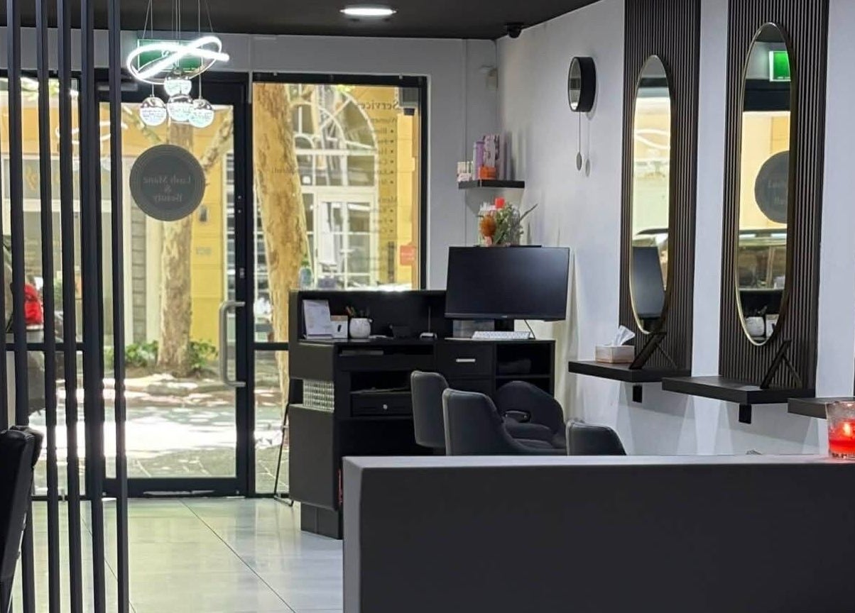 Interior of Yasu Hair in Perth, Western Australia, AU showing stylish salon setup with mirrors and seating.