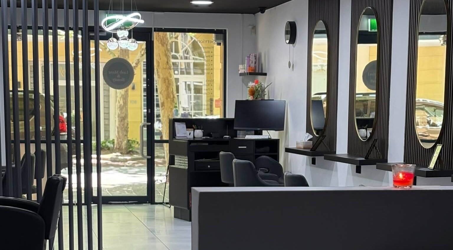 Interior of Yasu Hair in Perth, Western Australia, AU showing stylish salon setup with mirrors and seating.