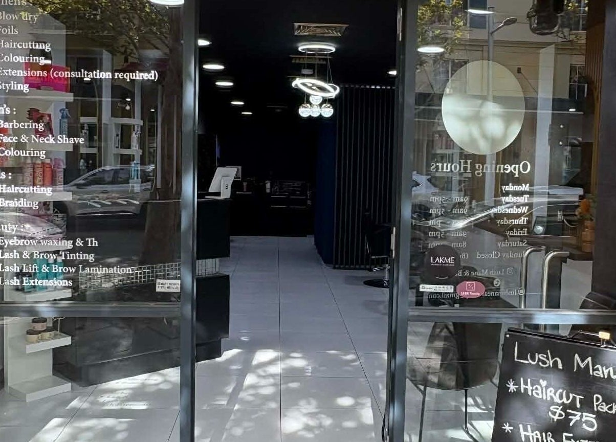 Entrance of Yasu Hair in Perth, Western Australia, AU showcasing service list and inviting ambiance.