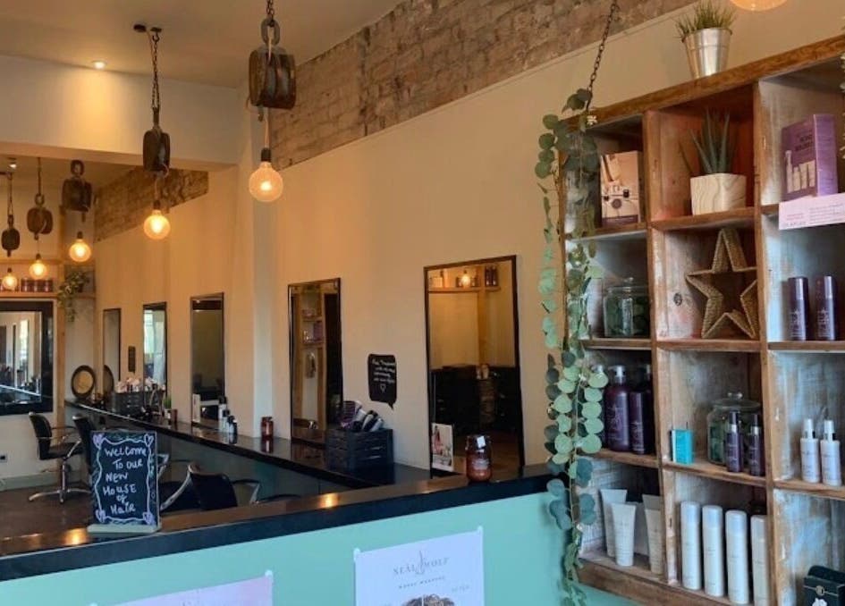 Interior of Emily White Hair salon in Forest Hall, England with stylish decor and product display.