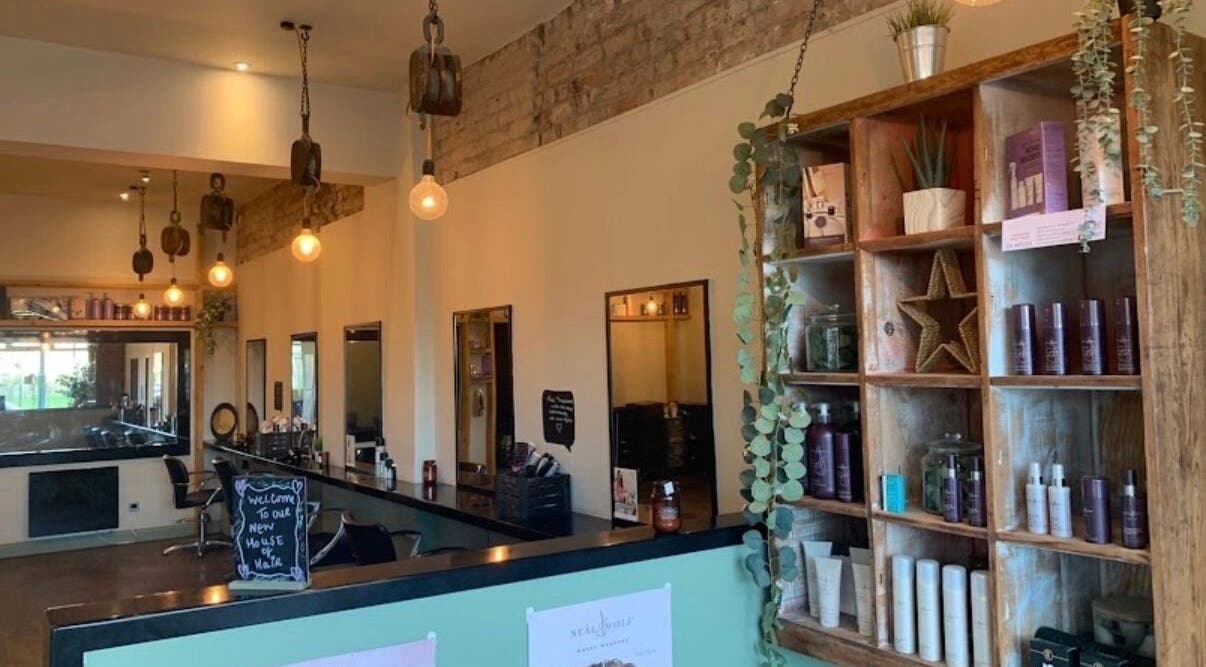 Interior of Emily White Hair salon in Forest Hall, England with stylish decor and product display.