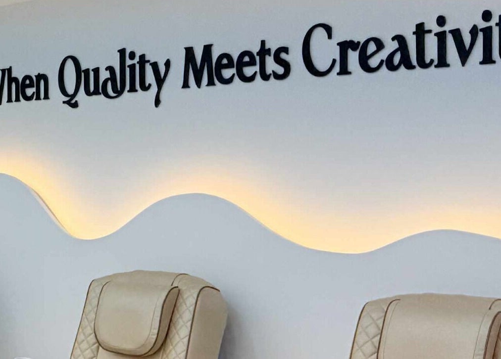 Luxurious seating with creative wall at Amber Glow Nails & Beauty in London, England, GB.