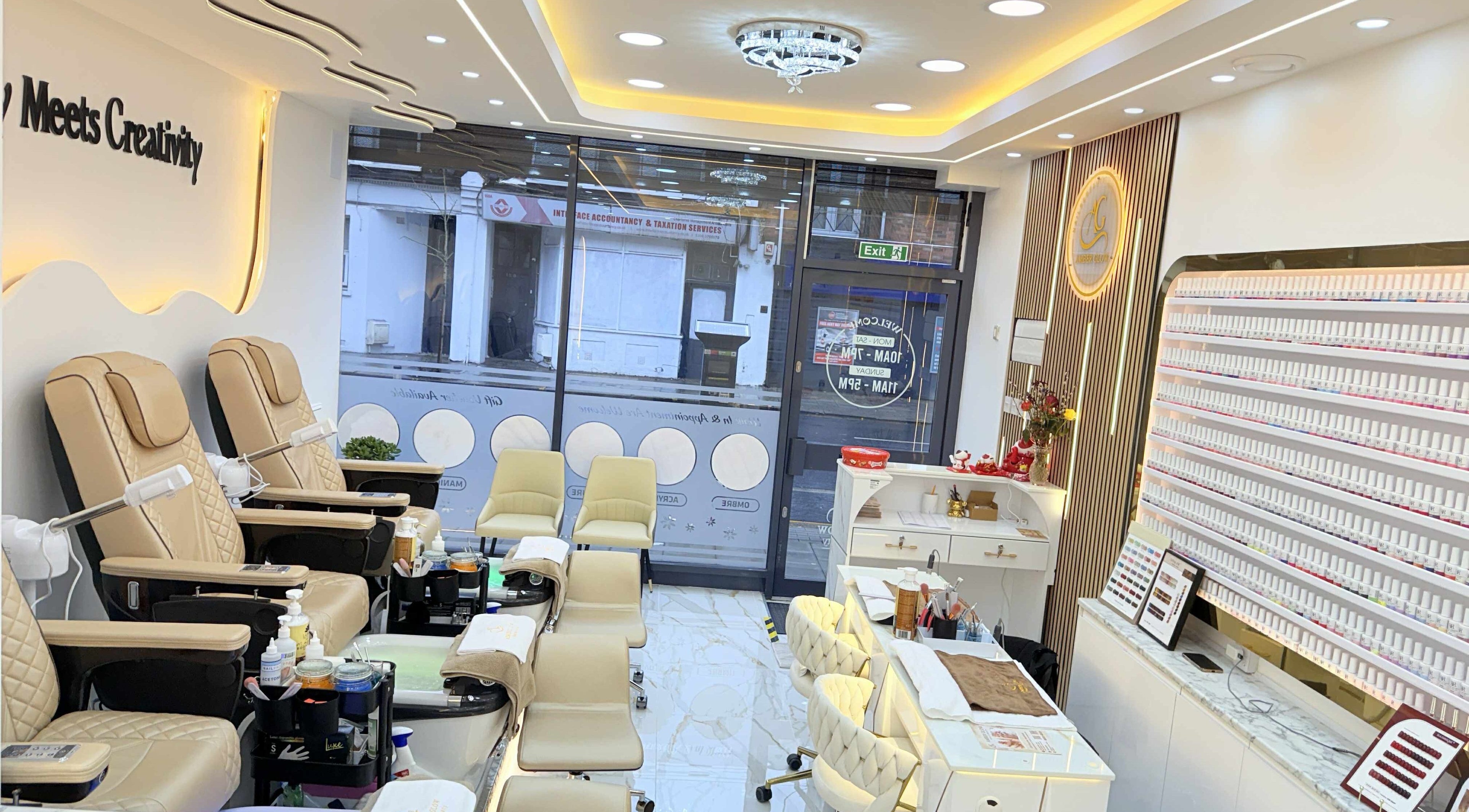 Spacious nail salon interior at Amber Glow Nails & Beauty in London, England, GB, featuring comfortable chairs.