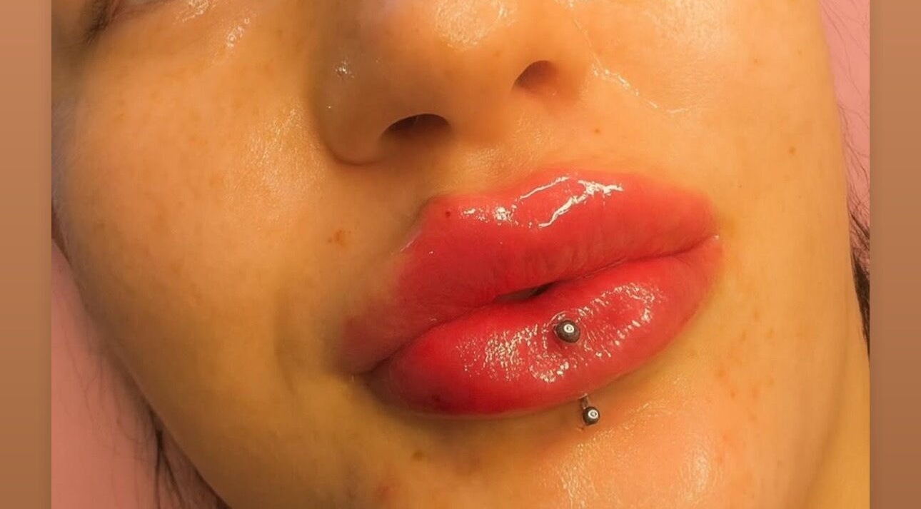 Close-up of glossy lips with piercing at Doll Faced, Enfield, England, GB.