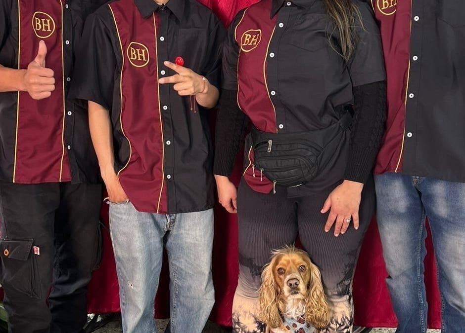 Barber’s House VIP team posing with a dog in Bogotá, D.c., Bogotá, D.c., CO, showcasing unity.