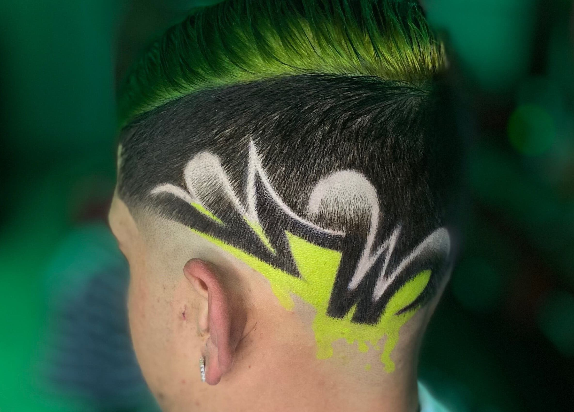 Creative hair design at Barber’s House VIP, Bogotá, D.c., CO, showcasing intricate patterns and vivid colors.