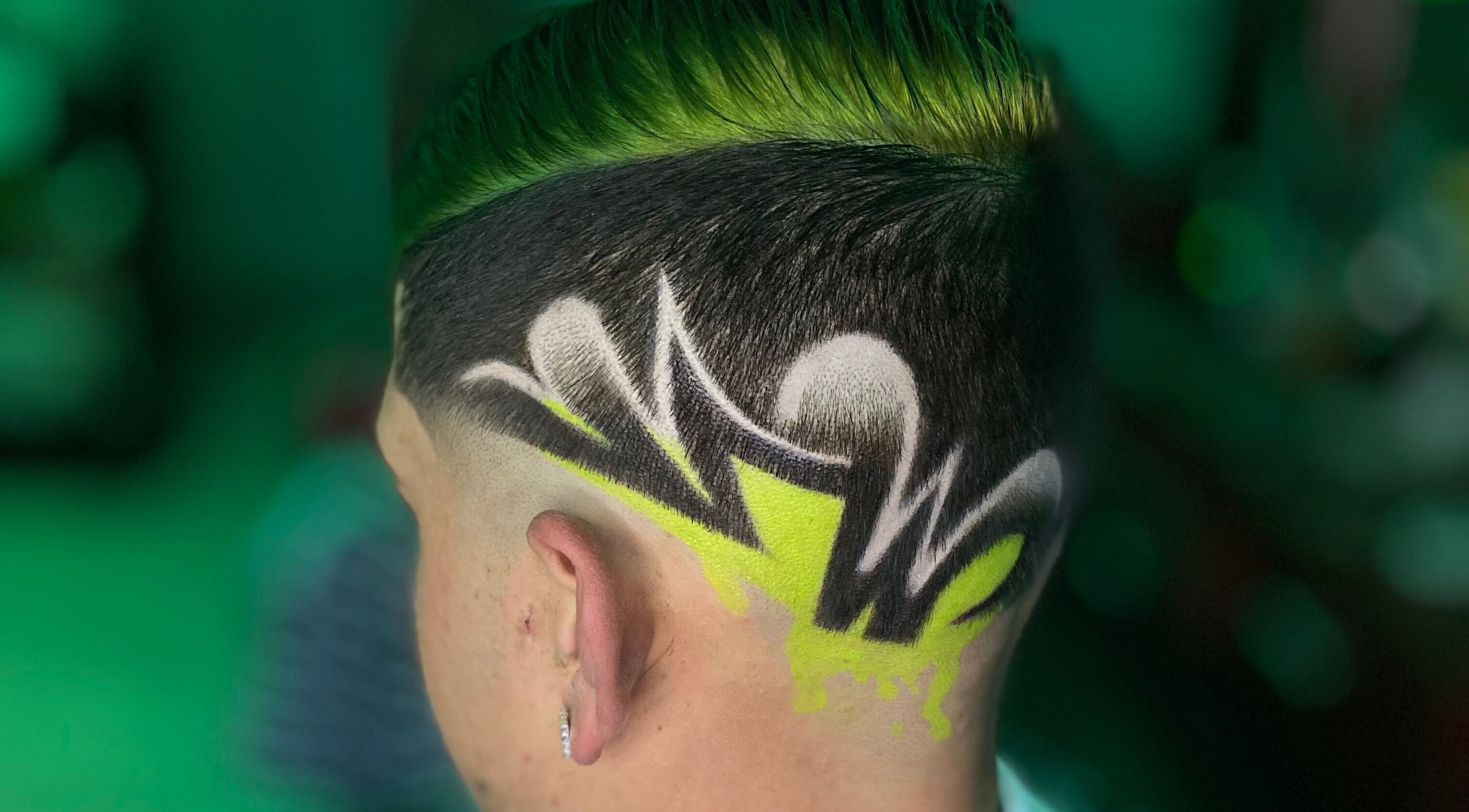 Creative hair design at Barber’s House VIP, Bogotá, D.c., CO, showcasing intricate patterns and vivid colors.