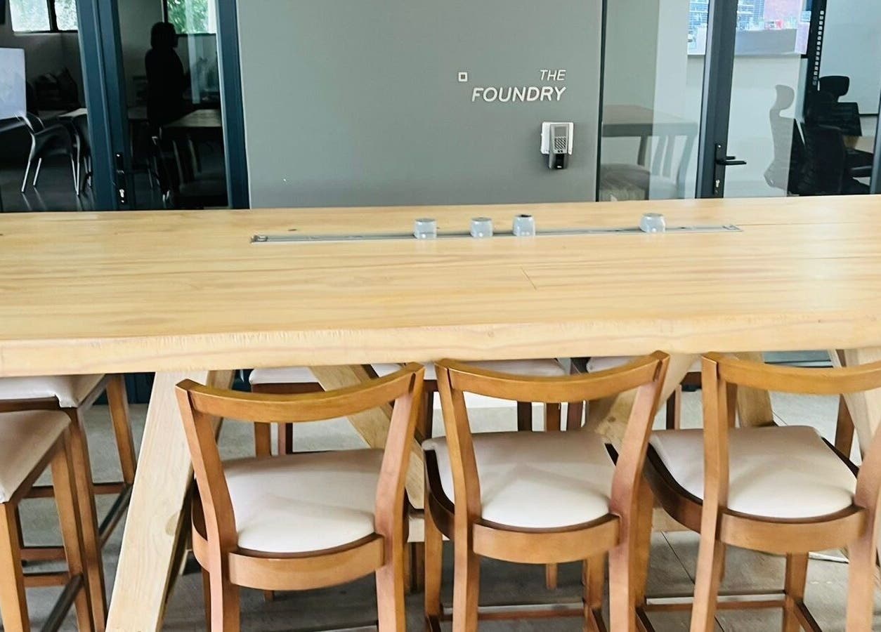 Modern wooden table and chairs at Indalo Botique, Midrand, Gauteng, ZA, ideal for meetings and relaxation.