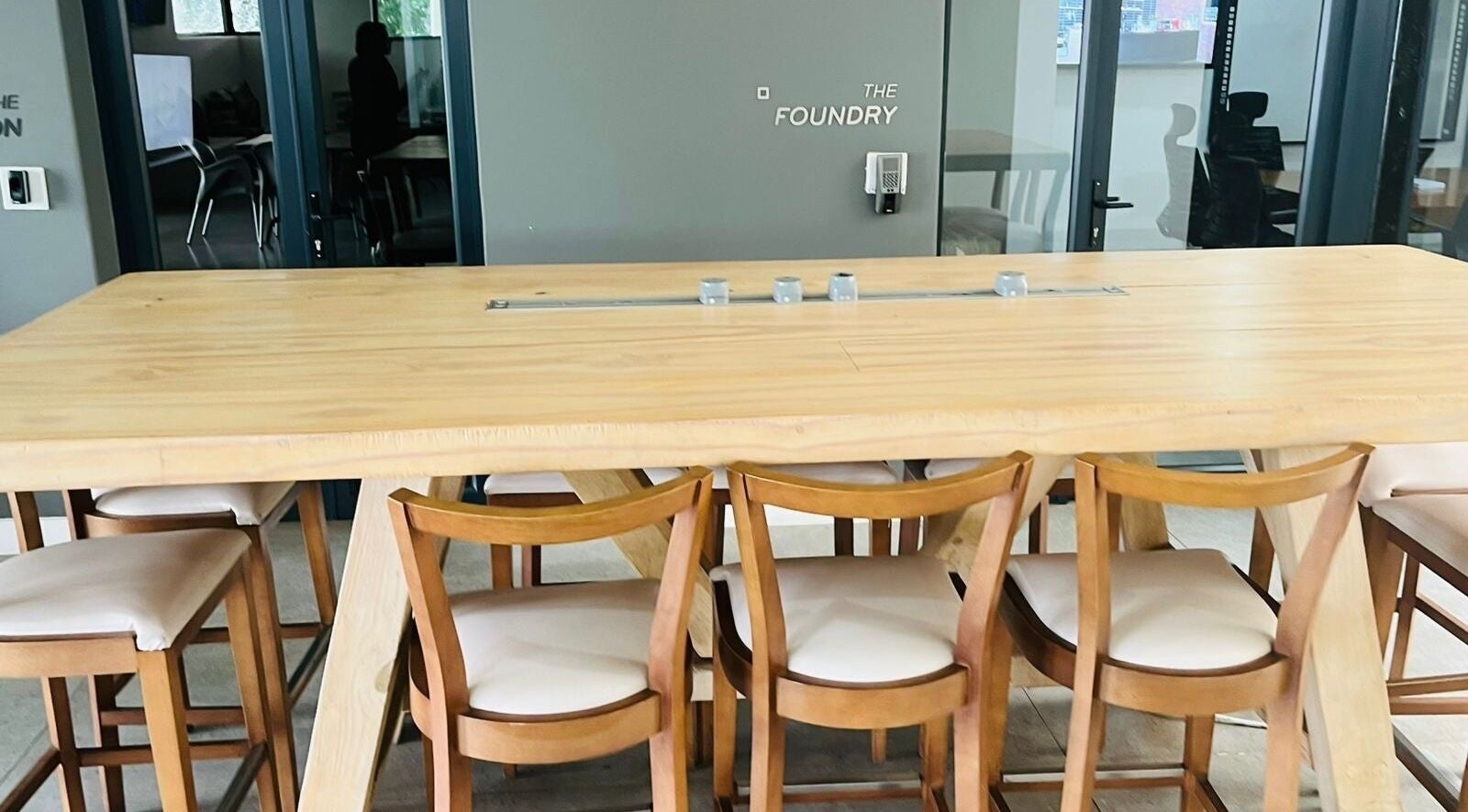 Modern wooden table and chairs at Indalo Botique, Midrand, Gauteng, ZA, ideal for meetings and relaxation.
