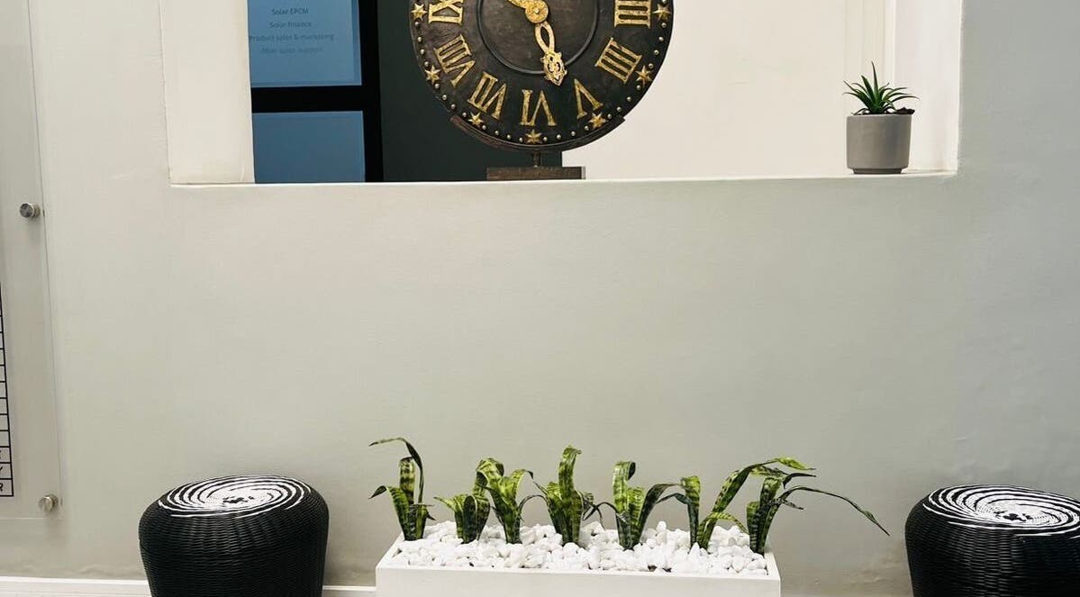 Decorative clock and plant at Indalo Botique, Midrand, Gauteng, ZA create a serene environment.