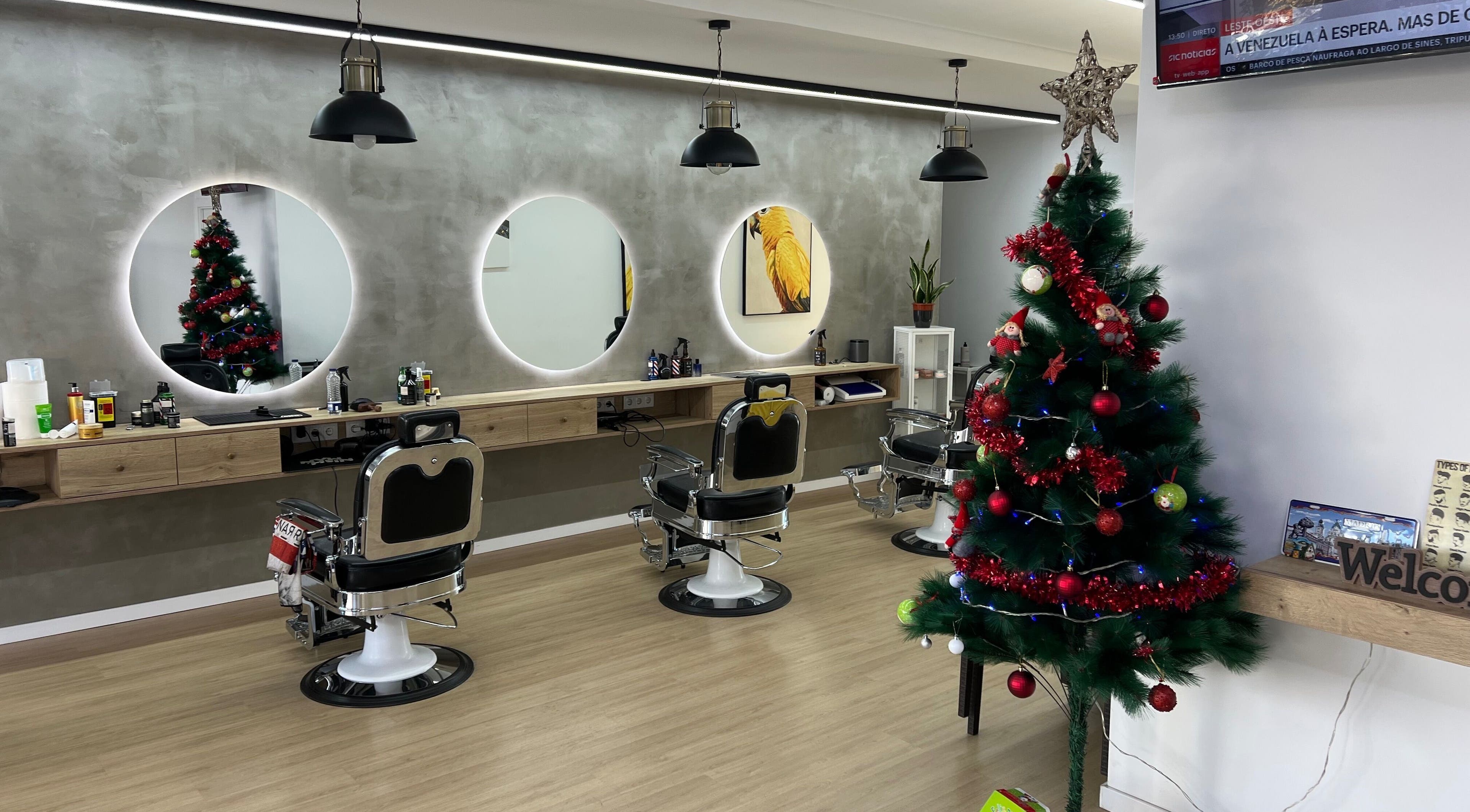 Barbearia Lusitania in Santo António Dos Cavaleiros, Lisboa, PT, decorated for Christmas with chairs and tree.