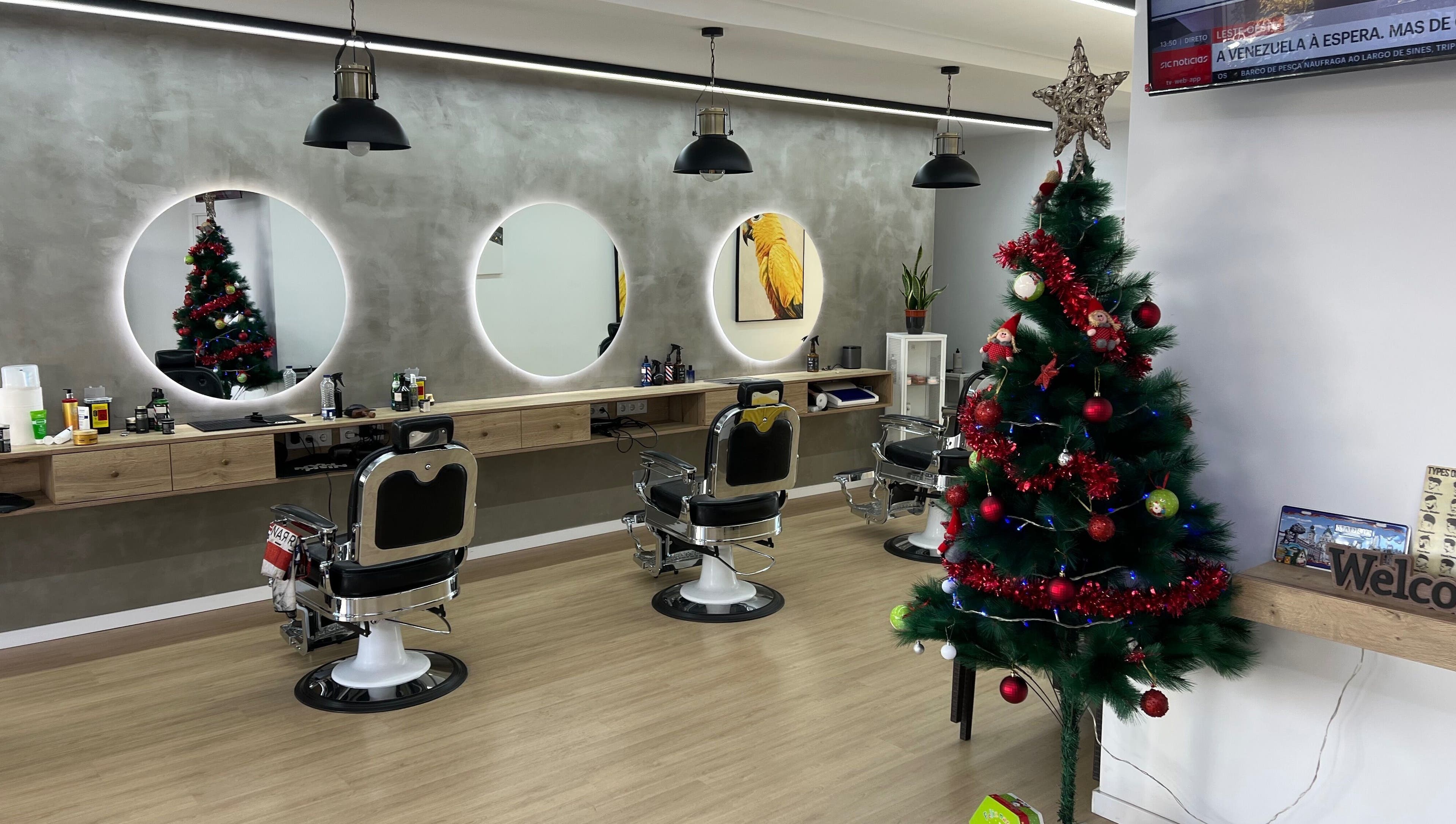Barbearia Lusitania in Santo António Dos Cavaleiros, Lisboa with Christmas decor and modern barber chairs.