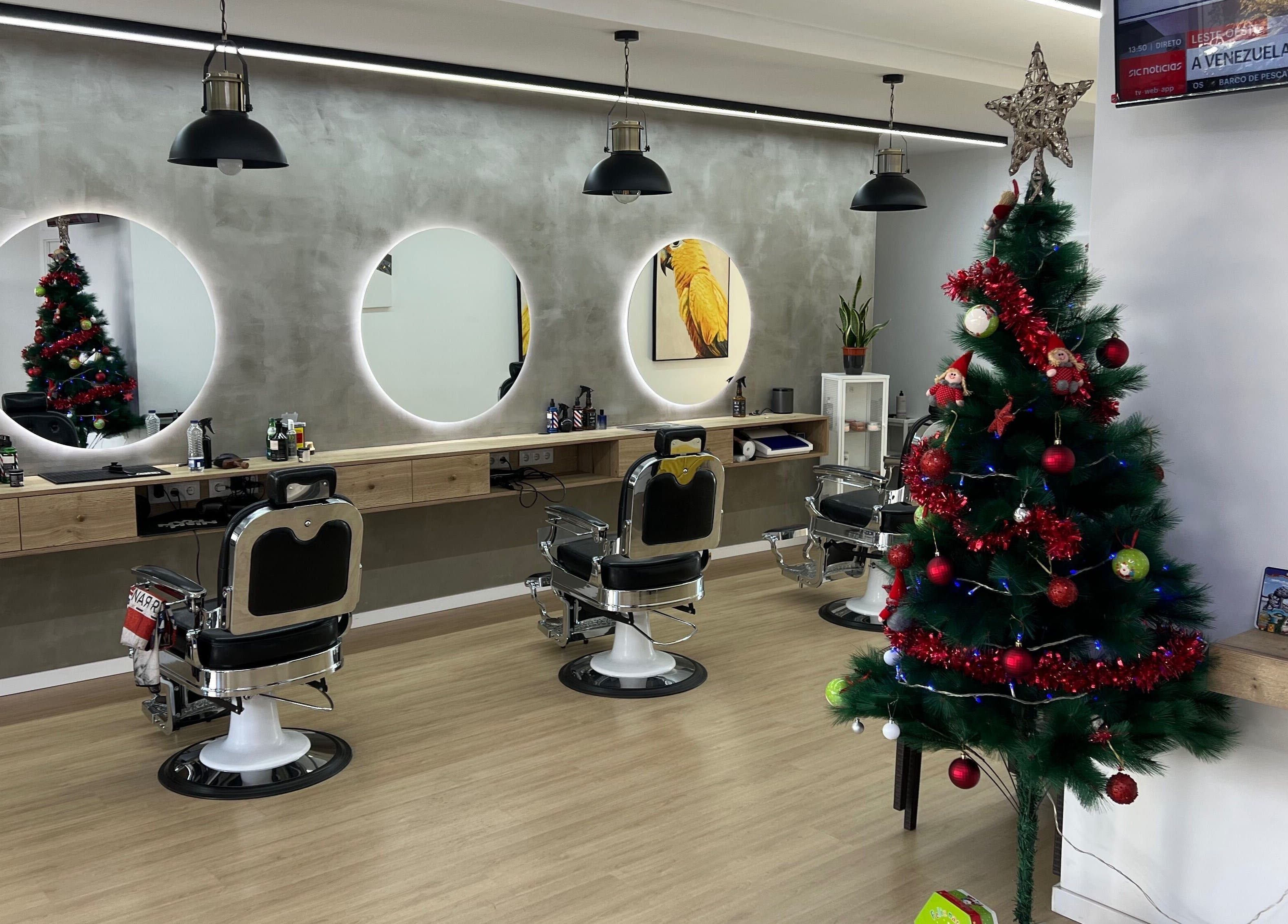 Barbearia Lusitania in Santo António Dos Cavaleiros, Lisboa with Christmas decor and modern barber chairs.