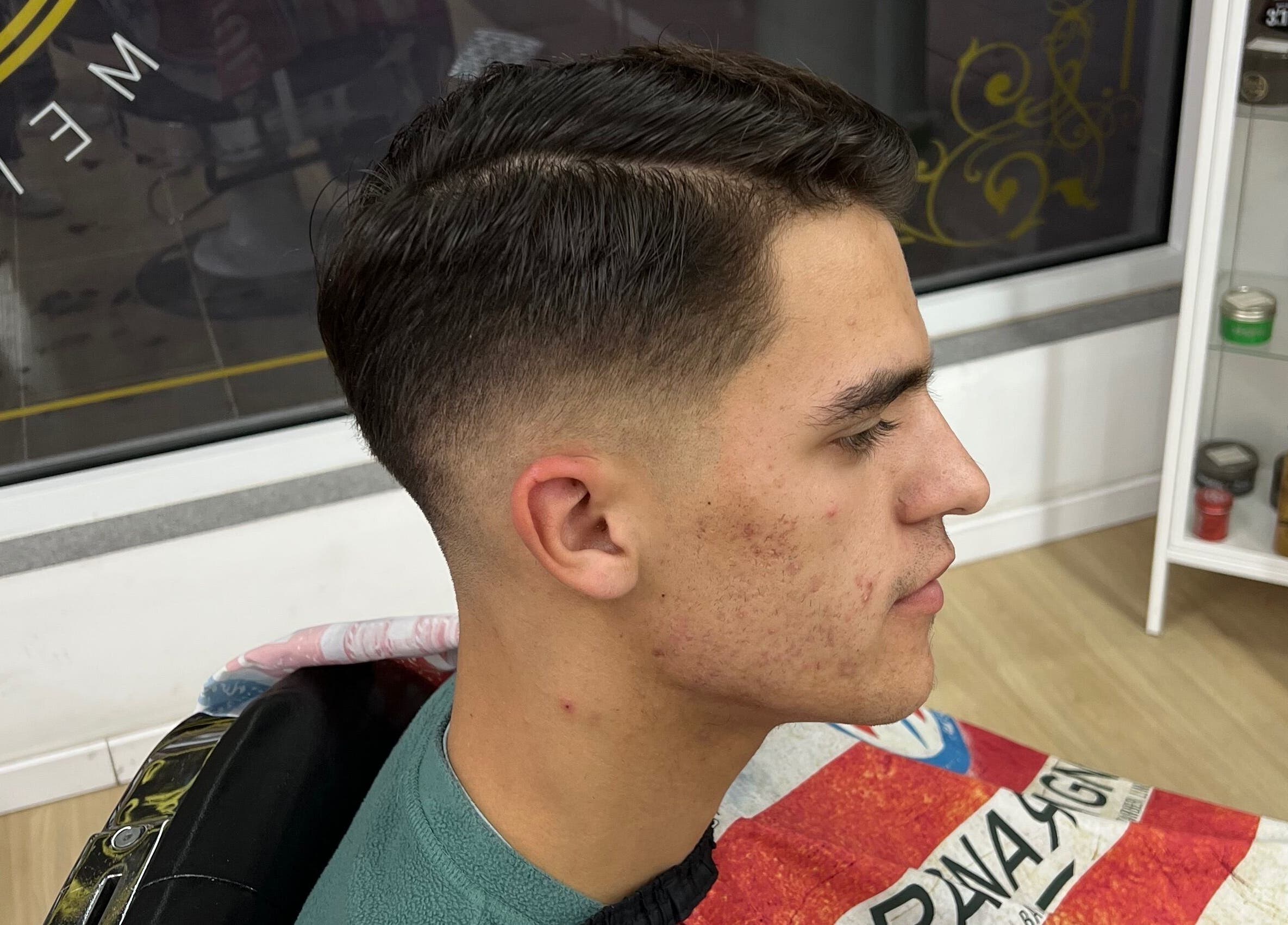Young man with fresh haircut at Barbearia Lusitania, Santo António Dos Cavaleiros, Lisboa, PT.