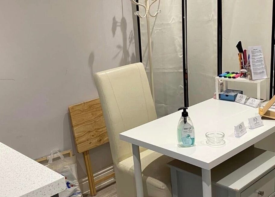Cozy nail care corner at Essex Foot Care, South Ockendon, England, GB featuring a chic white table and chair.