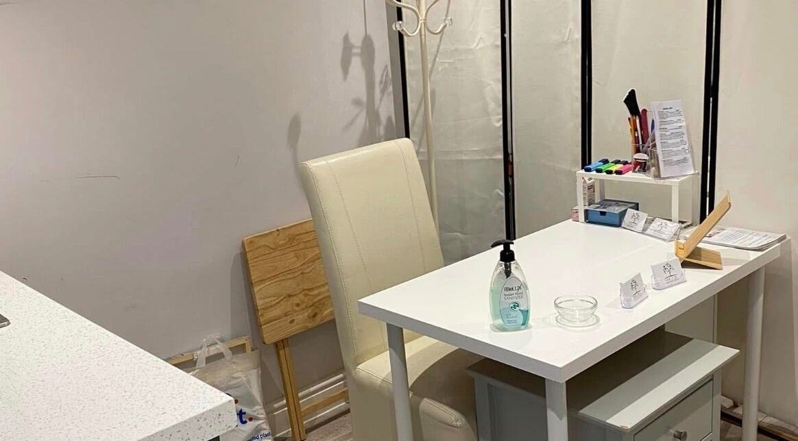 Cozy nail care corner at Essex Foot Care, South Ockendon, England, GB featuring a chic white table and chair.