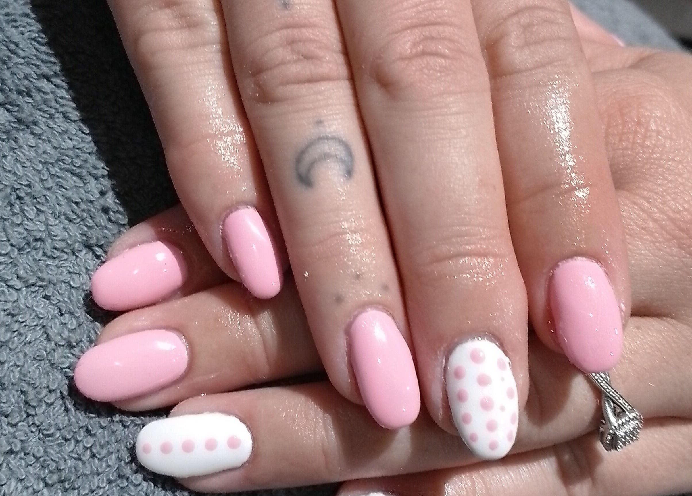 Elegant pink polka dot manicure at Beauty Hause, Alberton, Gauteng, ZA, showcasing nail art expertise.