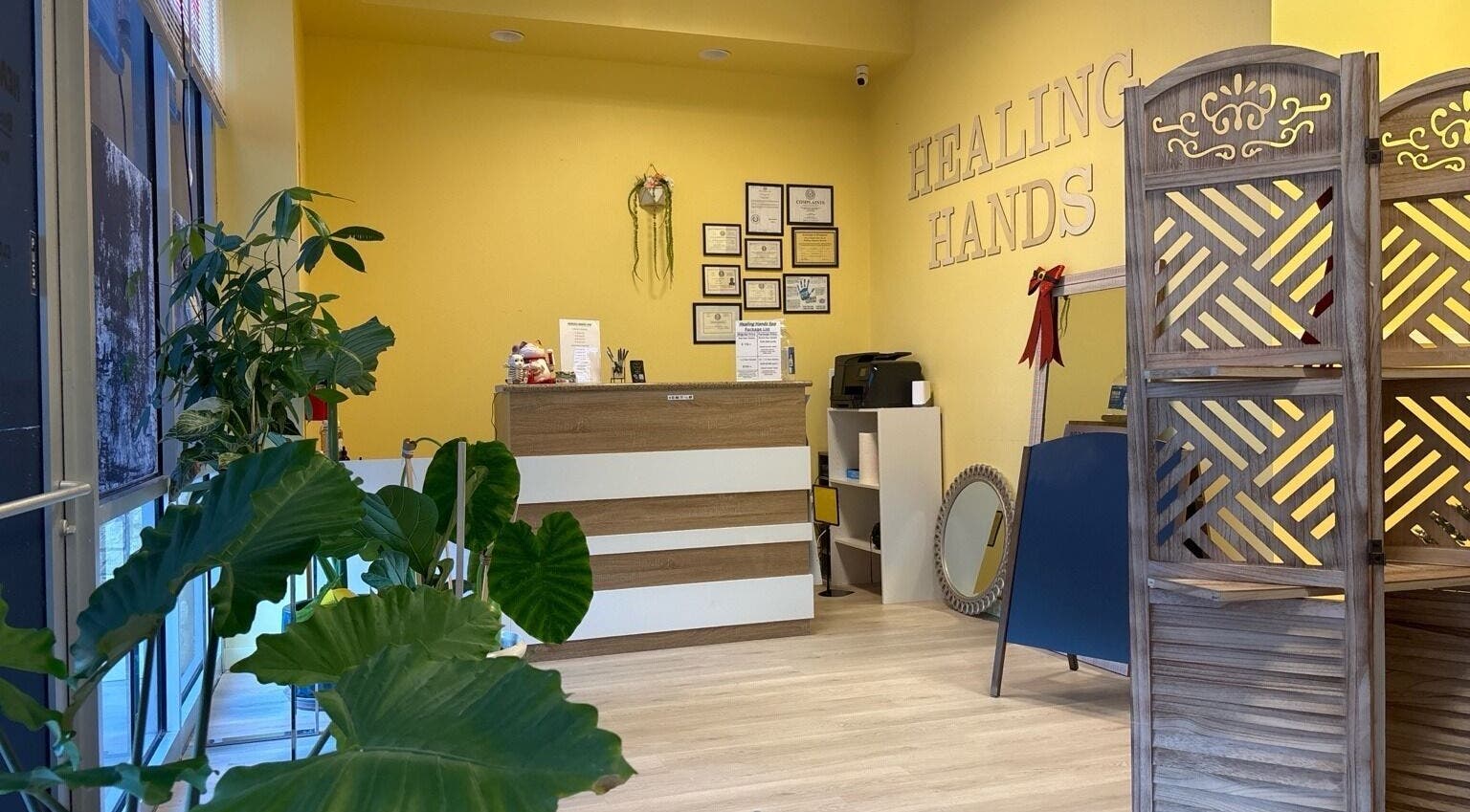 Reception area of Healing Hands Massage & Facial SPA in Round Rock, Texas, US with inviting decor and plants.