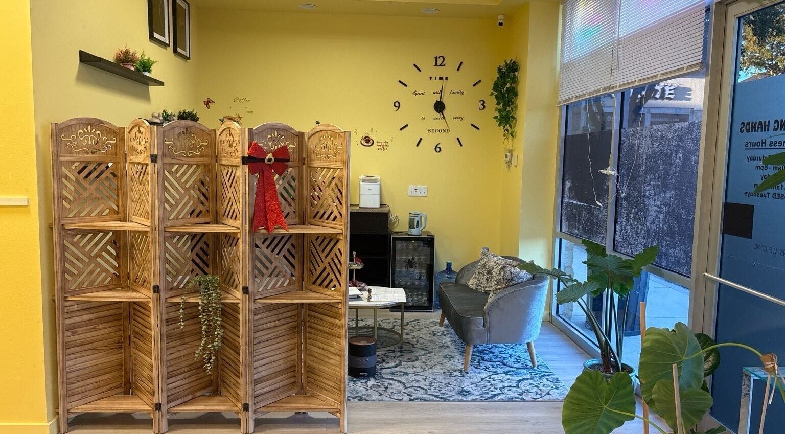 Cozy waiting area in Healing Hands Massage & Facial SPA, Round Rock, Texas, US with decorative partition.