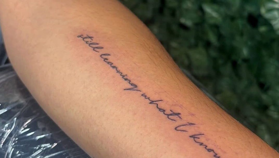 Elegant script tattoo on forearm at TaintedTats, Charlotte, North Carolina, US.