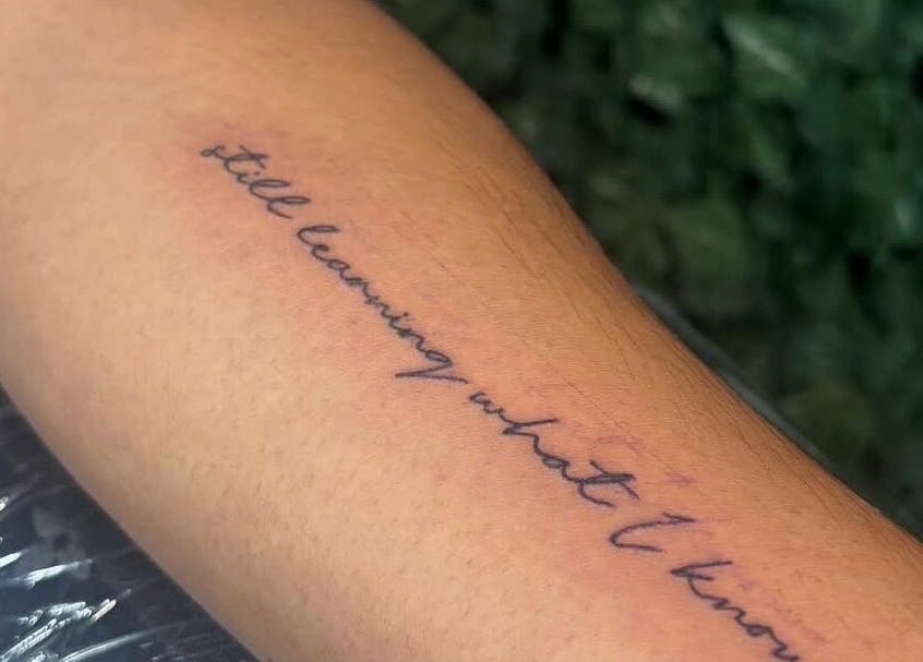 Elegant script tattoo on forearm at TaintedTats, Charlotte, North Carolina, US.