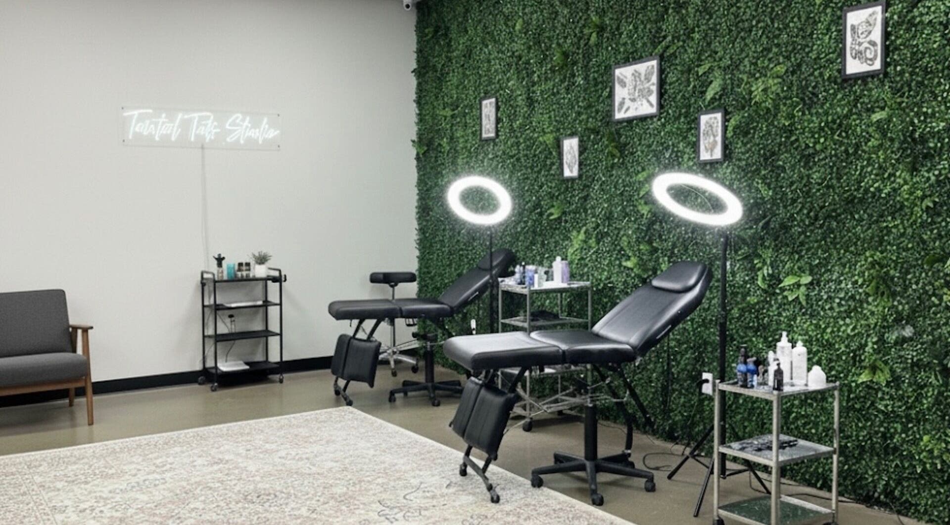 TaintedTats tattoo studio in Charlotte, North Carolina, US, featuring relaxing green decor and professional equipment.