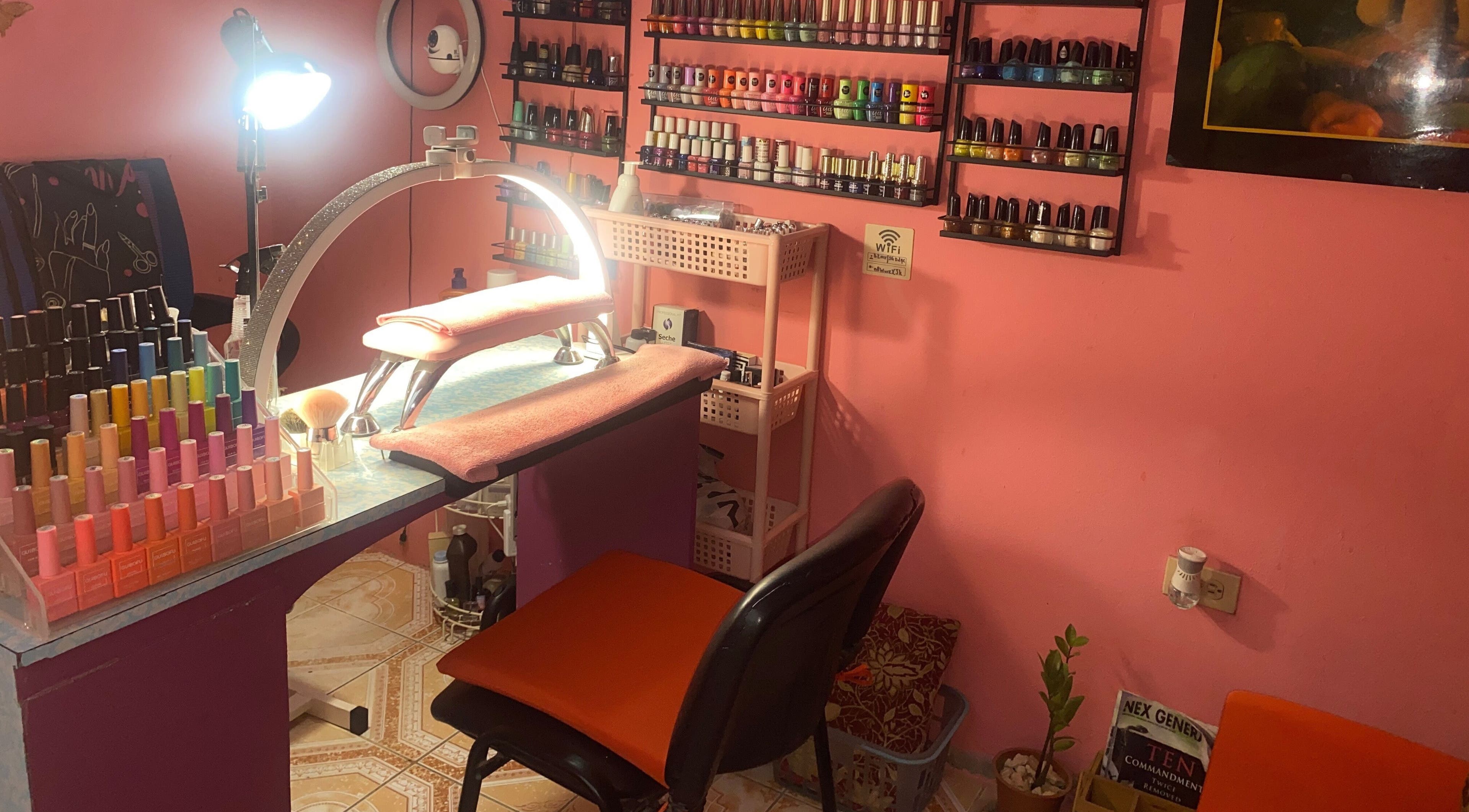 Cozy nail station at Lisane’s Nail Addiction Bar in Portmore, St. Catherine Parish, JM, showcasing colorful polishes.