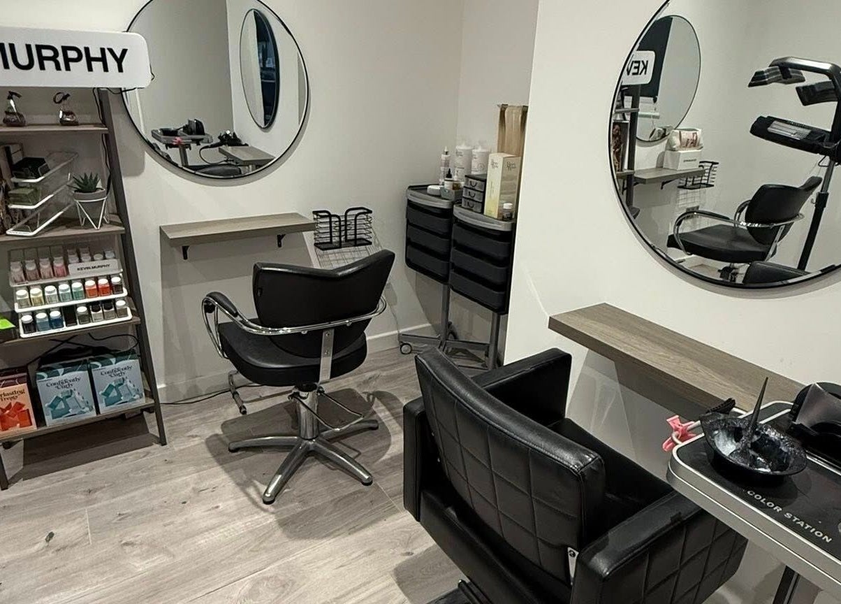 Modern salon interior at Hair By Jen, Jersey, St Saviour, JE, featuring sleek chairs and beauty products.
