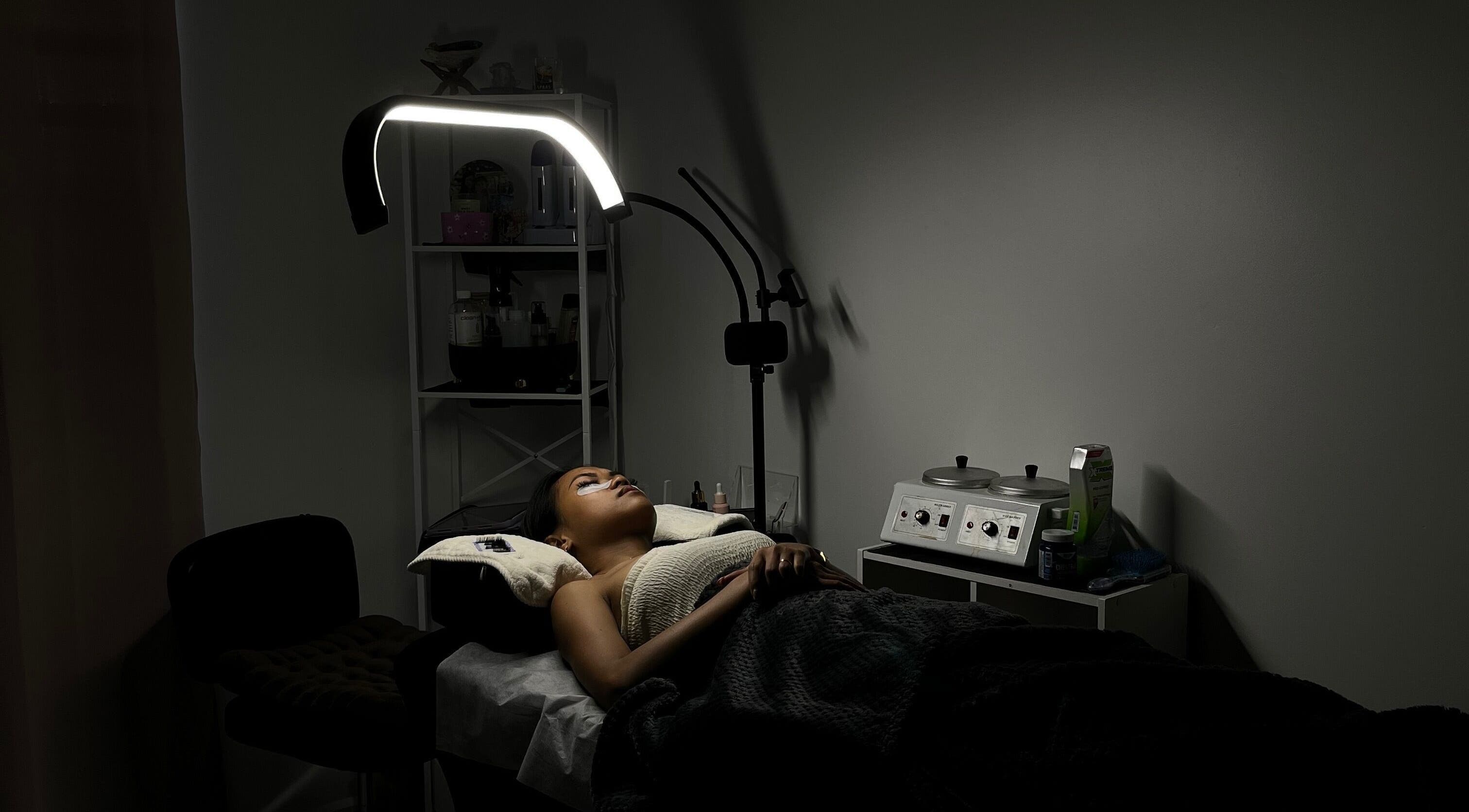 Serene treatment room at POISE BEAUTY, Paramaribo, SR, showcasing a client enjoying a spa session under soft lighting.