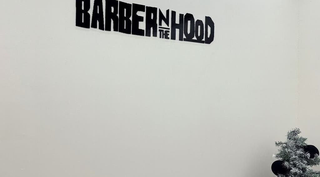 Barber N’ The Hood sign on wall with a small plant, Kralendijk, Bonaire, BQ.