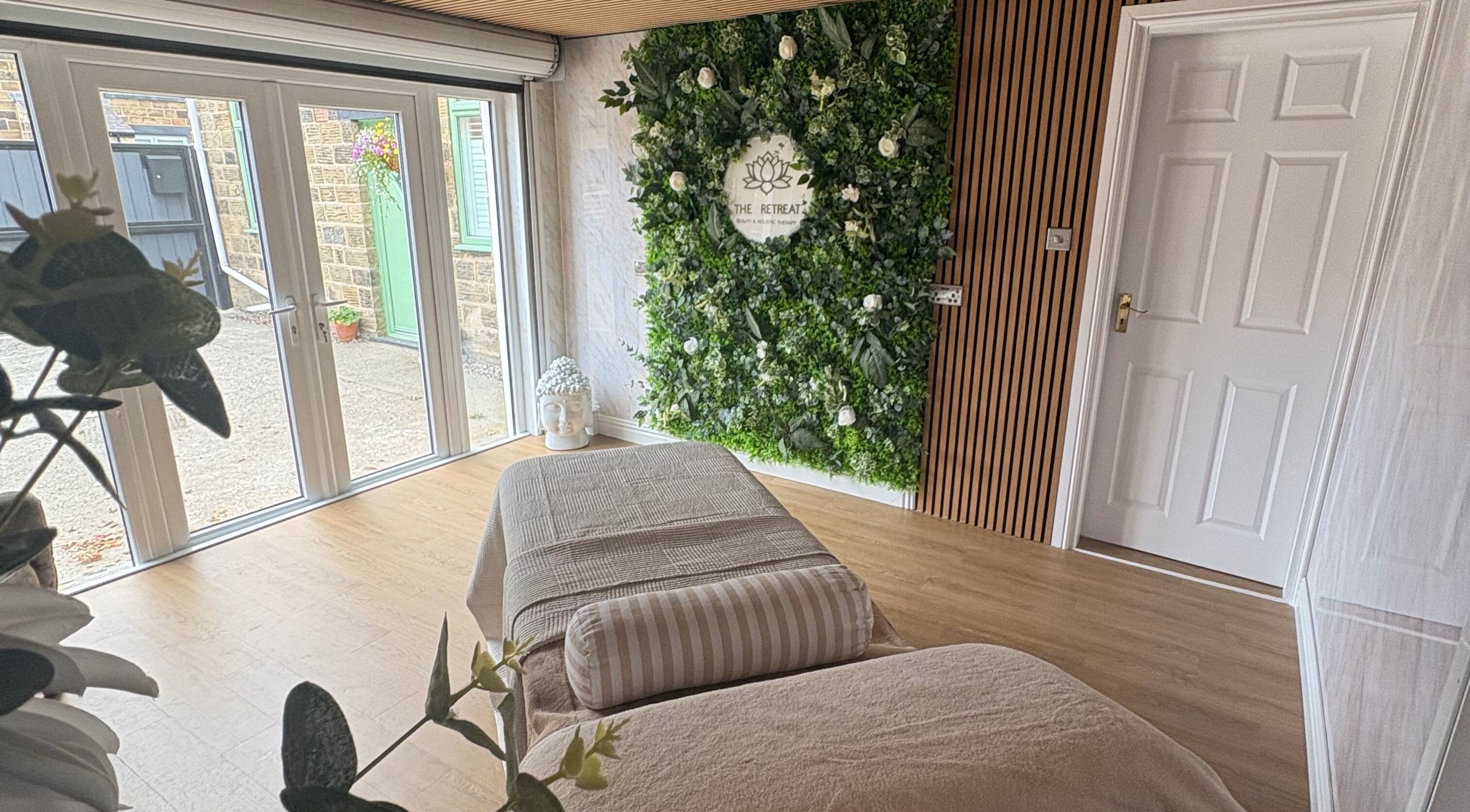 Relaxing treatment room at The Retreat, Barnsley, England, GB with a lush green plant wall.