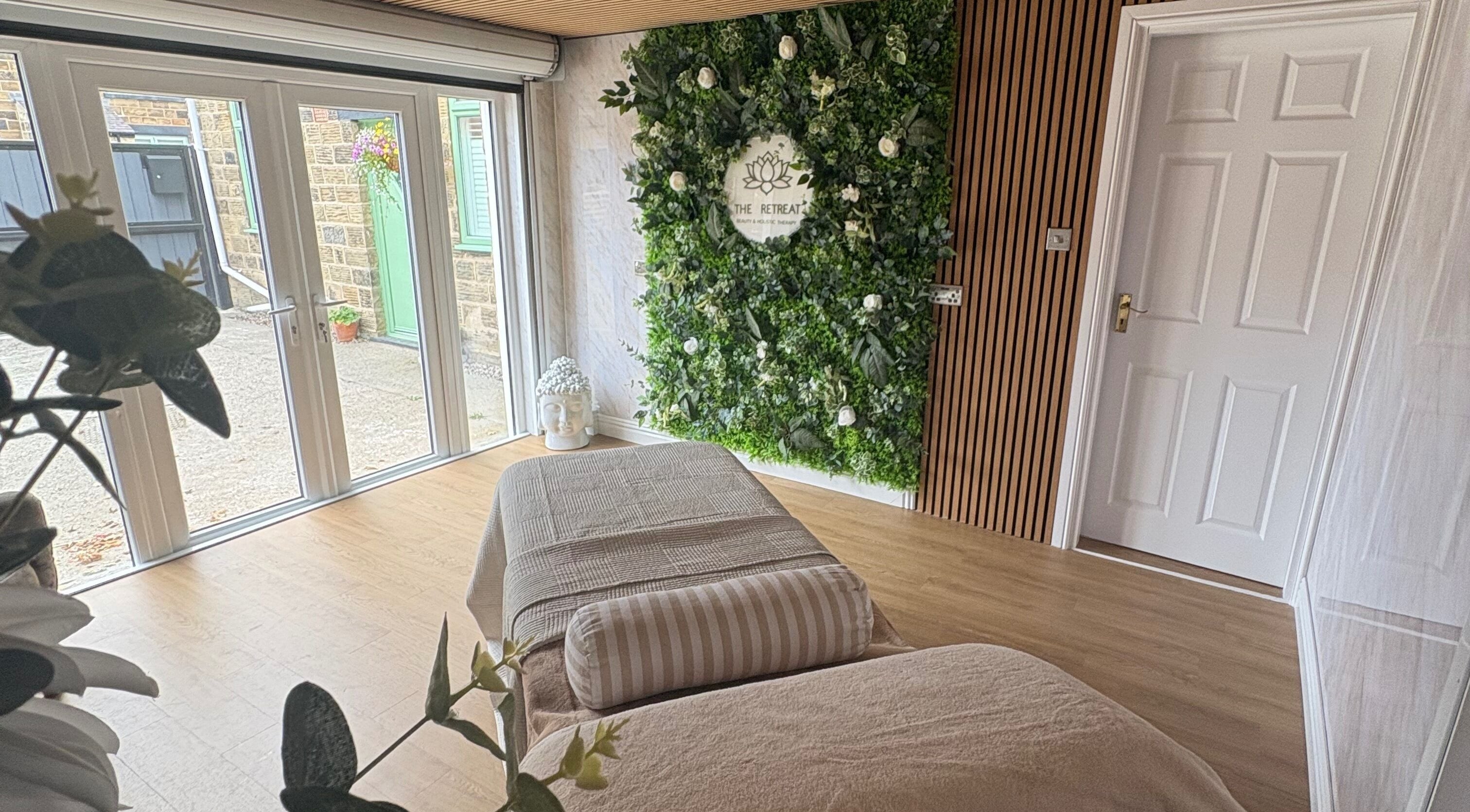 Relaxing treatment room at The Retreat, Barnsley, England, GB with a lush green plant wall.