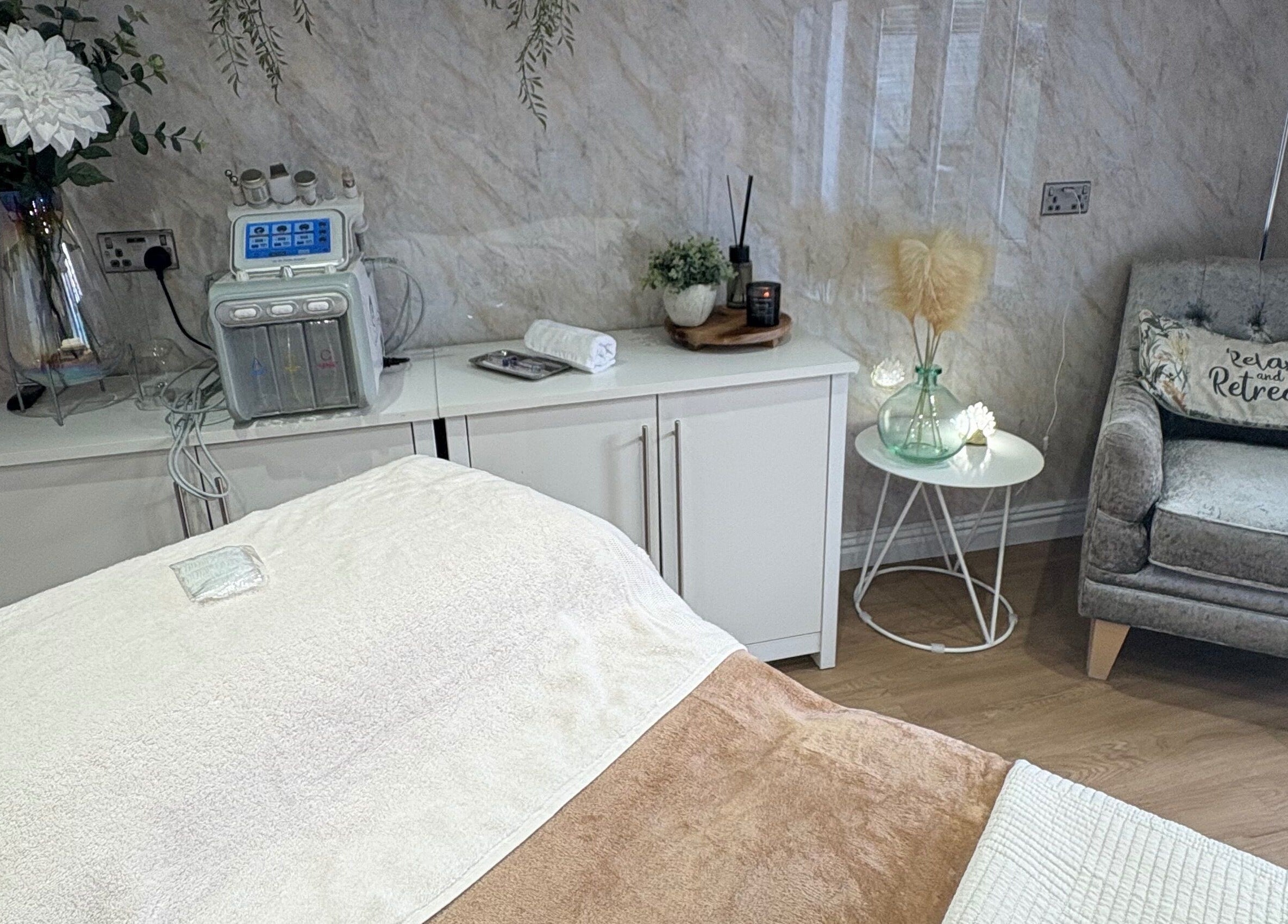 Cozy treatment room at The Retreat in Barnsley, England, GB featuring plush seating and soothing decor.