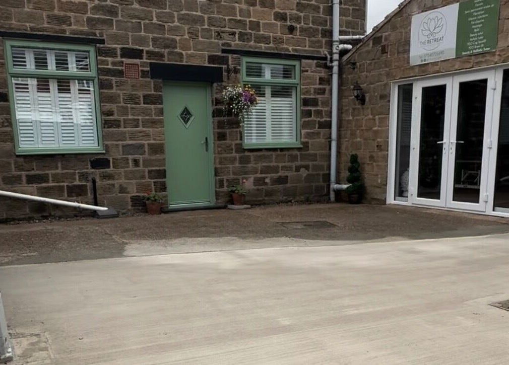 Front view of The Retreat, Barnsley, England, GB with stone walls and inviting green door.