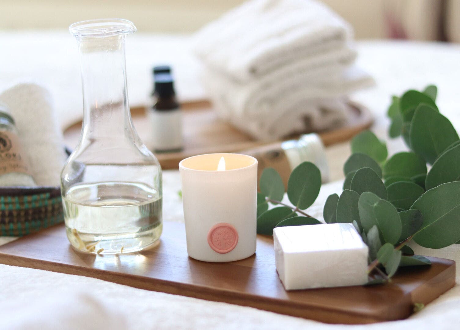 Relaxing spa setup at Zen Body Wellness with candle, oils, and eucalyptus in Centreville, Virginia, US.