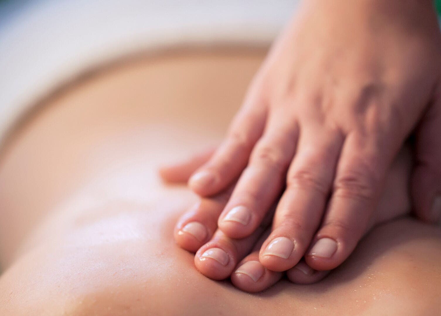 Hands massage back at Zen Body Wellness in Centreville, Virginia, US, enhancing relaxation and well-being.