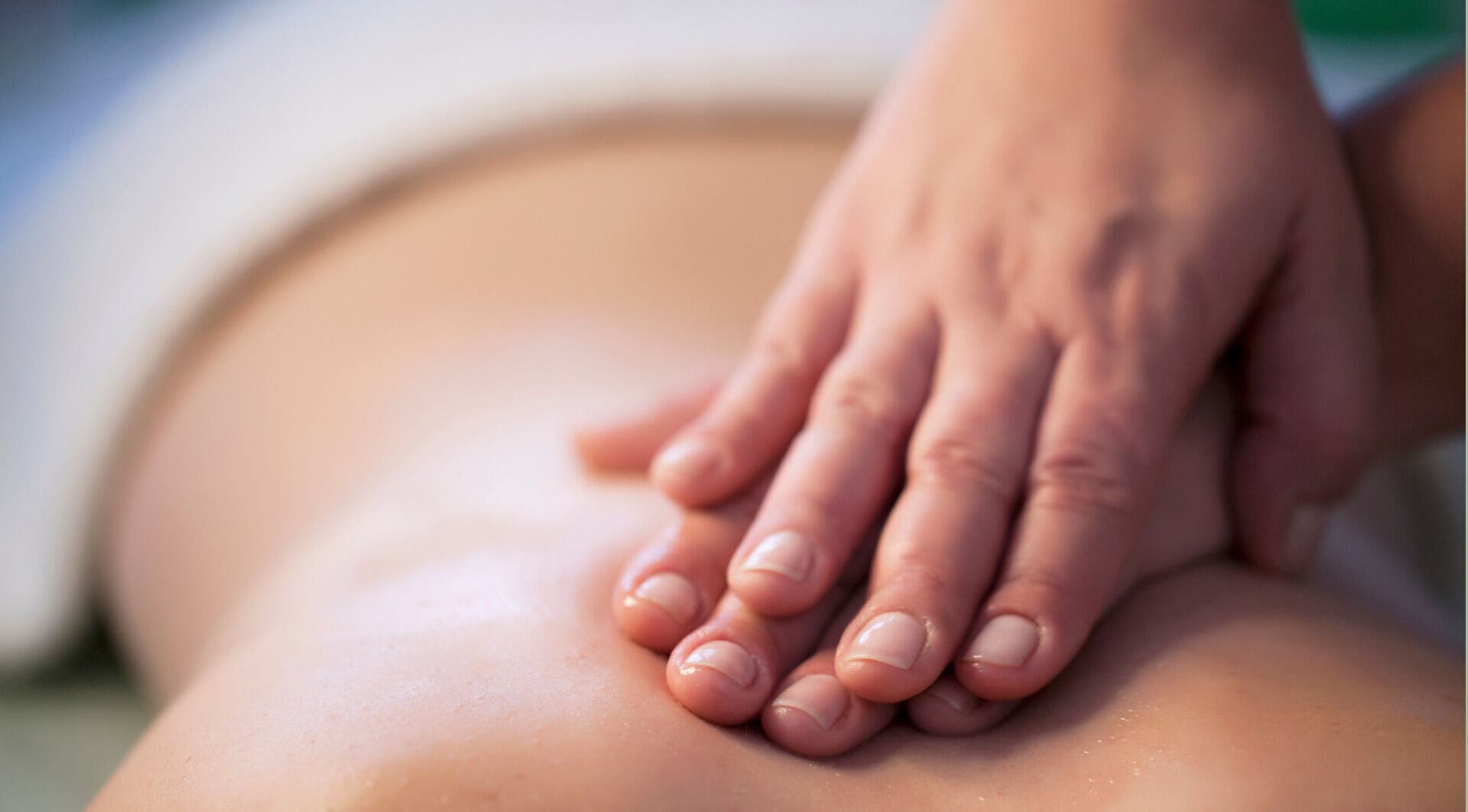 Hands massage back at Zen Body Wellness in Centreville, Virginia, US, enhancing relaxation and well-being.