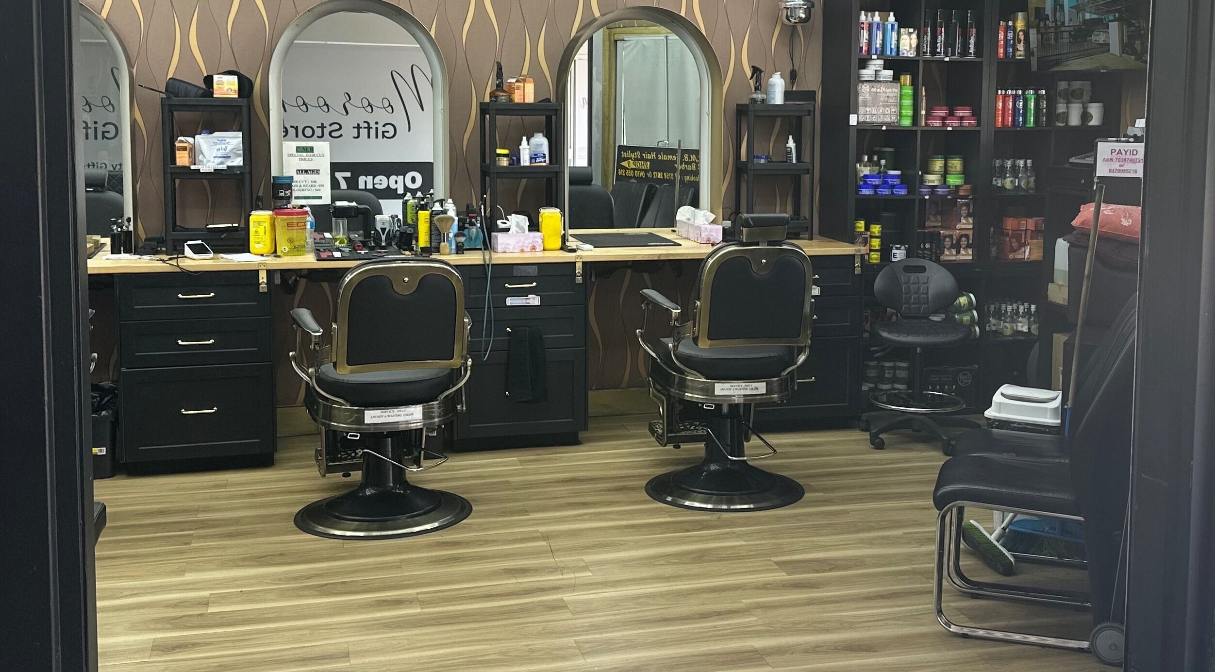 Interior view of Cutting Master Barbershop in Moorooka, Queensland, AU featuring barber chairs and grooming products.