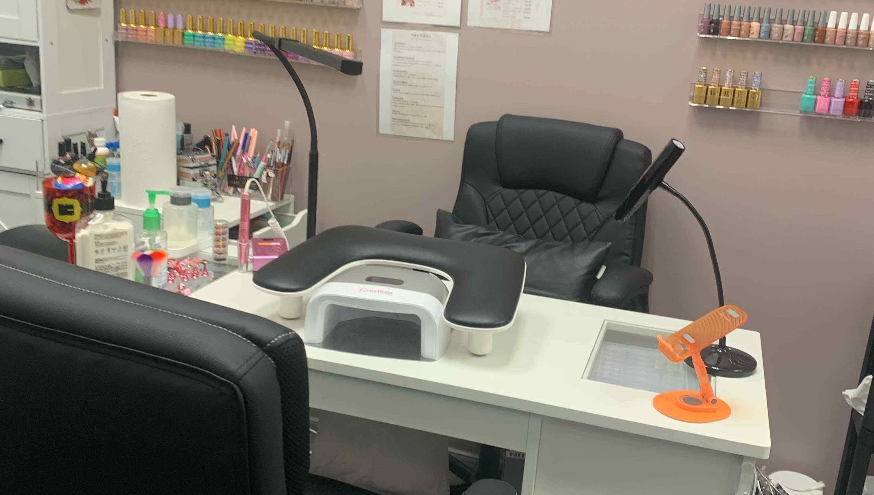 Nail station at Gloss N Bare Studio, Midvale, Utah with tools and polish display.