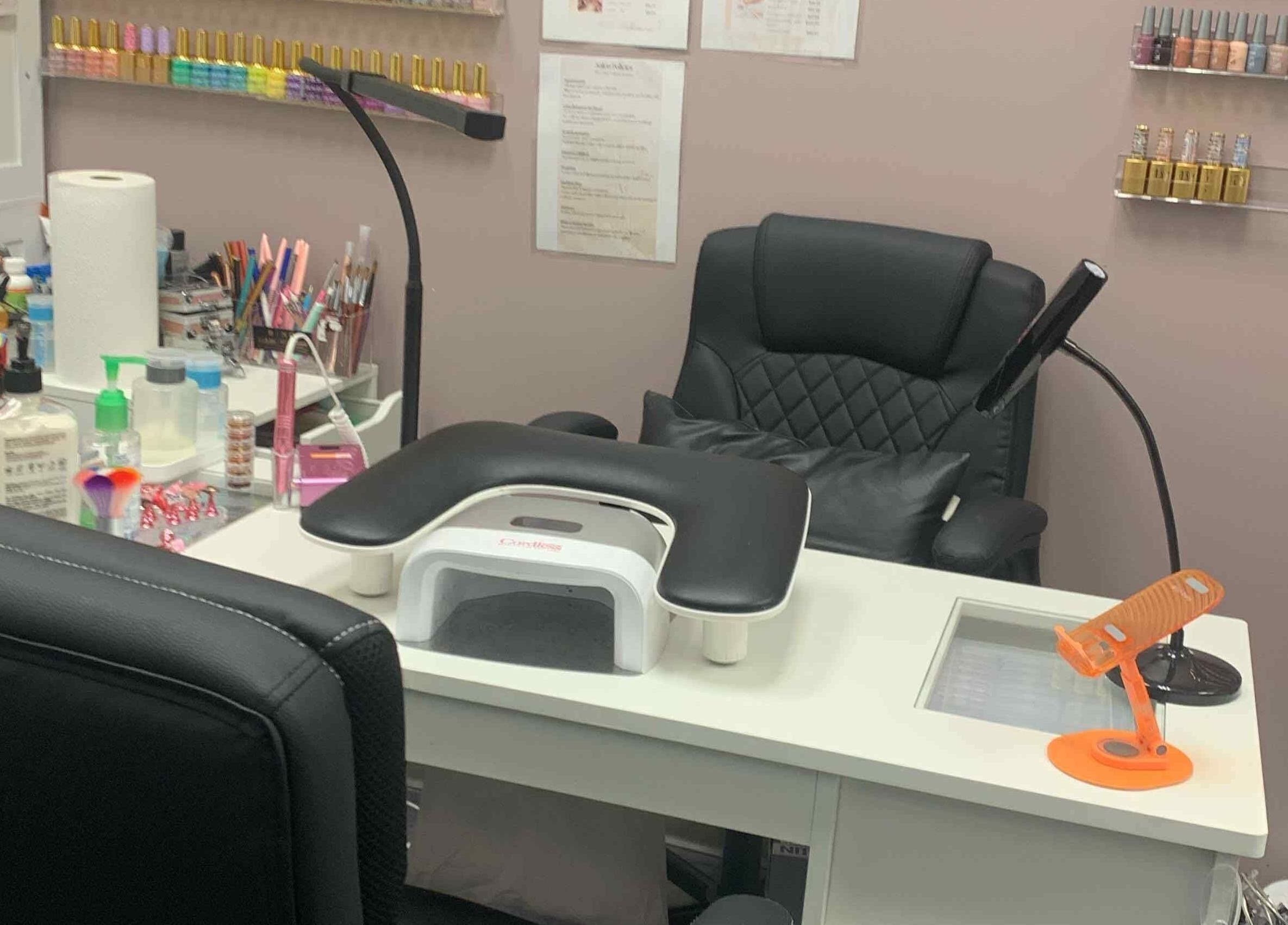 Nail station at Gloss N Bare Studio, Midvale, Utah with tools and polish display.