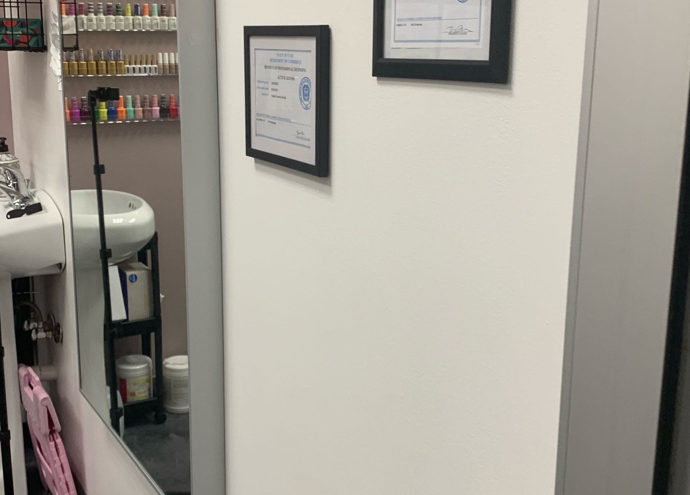 Modern nail polish display and sink area at Gloss N Bare Studio in Midvale, Utah, US.