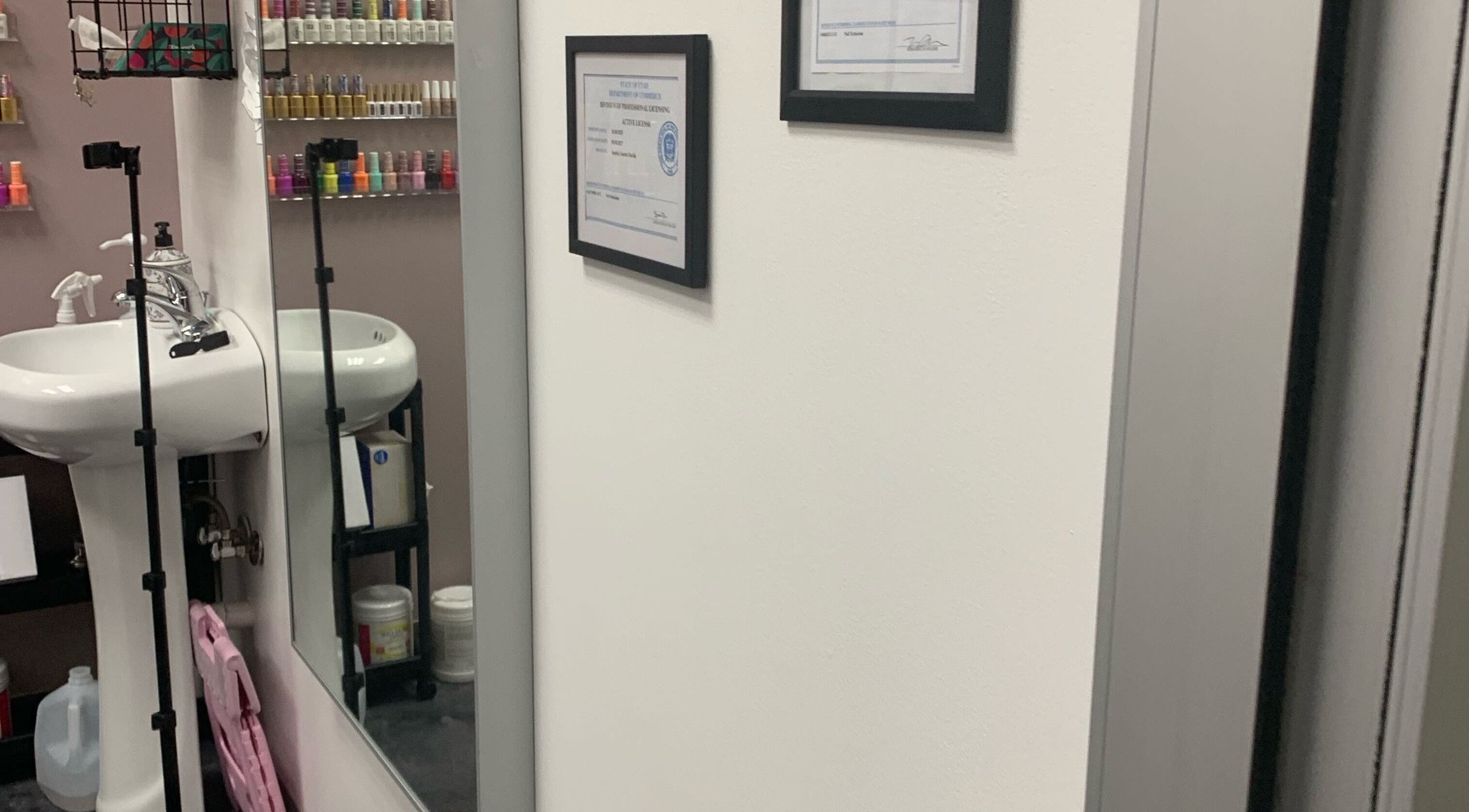 Modern nail polish display and sink area at Gloss N Bare Studio in Midvale, Utah, US.