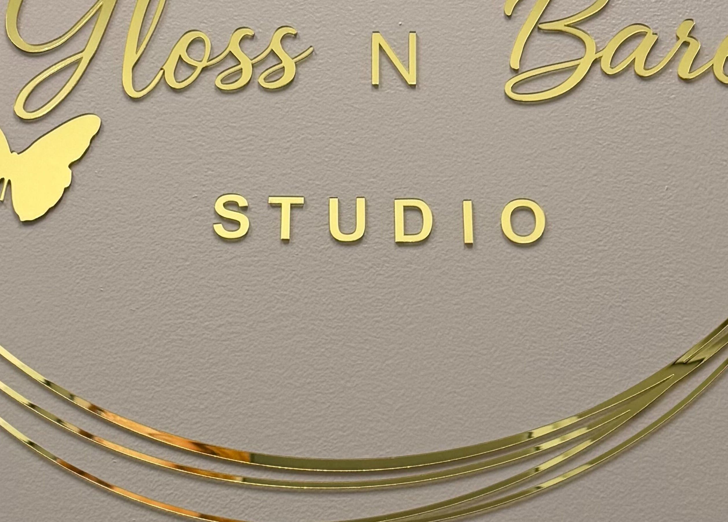 Gloss N Bare Studio elegant golden logo on wall, Midvale, Utah, US.