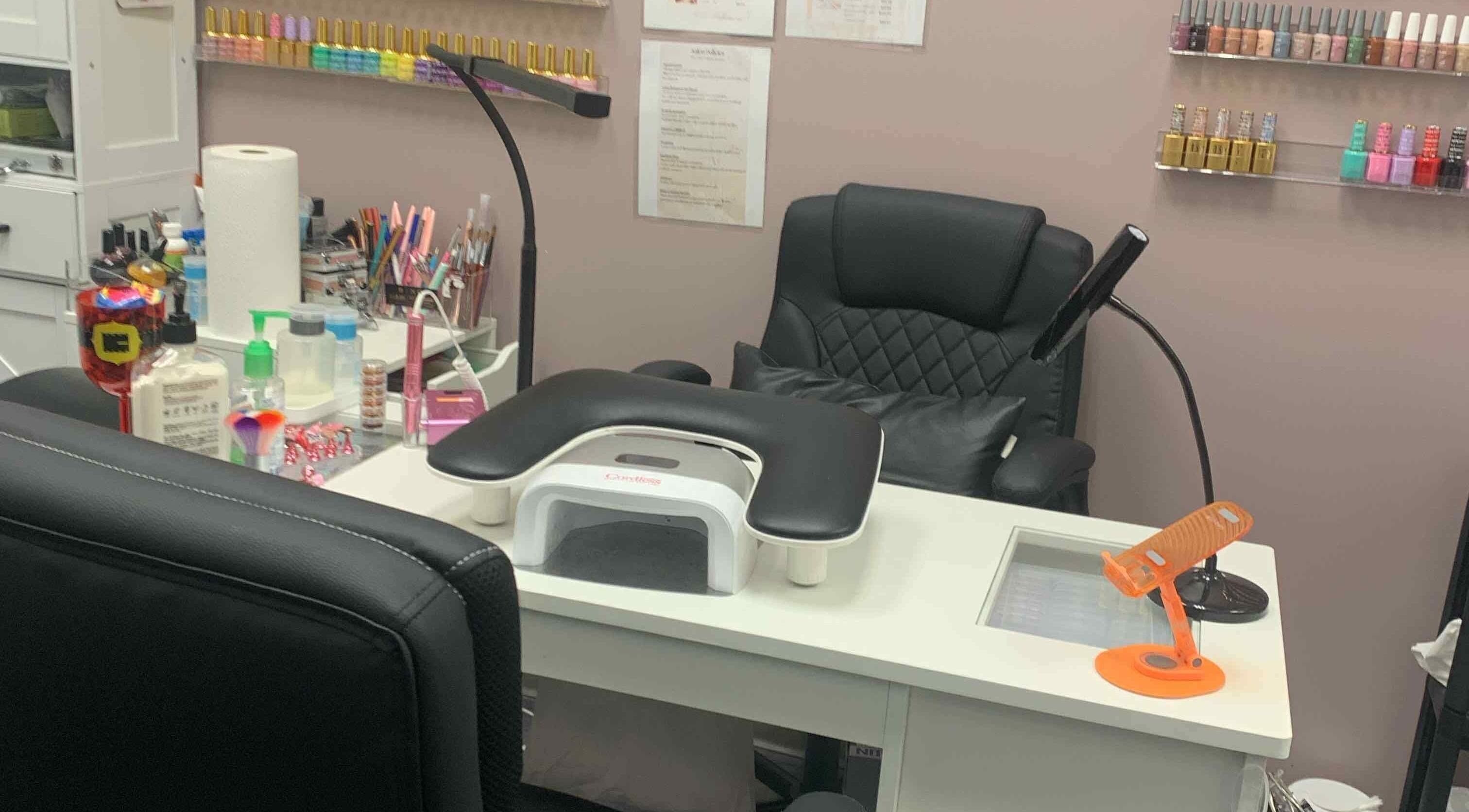 Gloss N Bare Studio's sleek manicure station in Midvale, Utah, US, featuring modern equipment and vibrant nail polish.