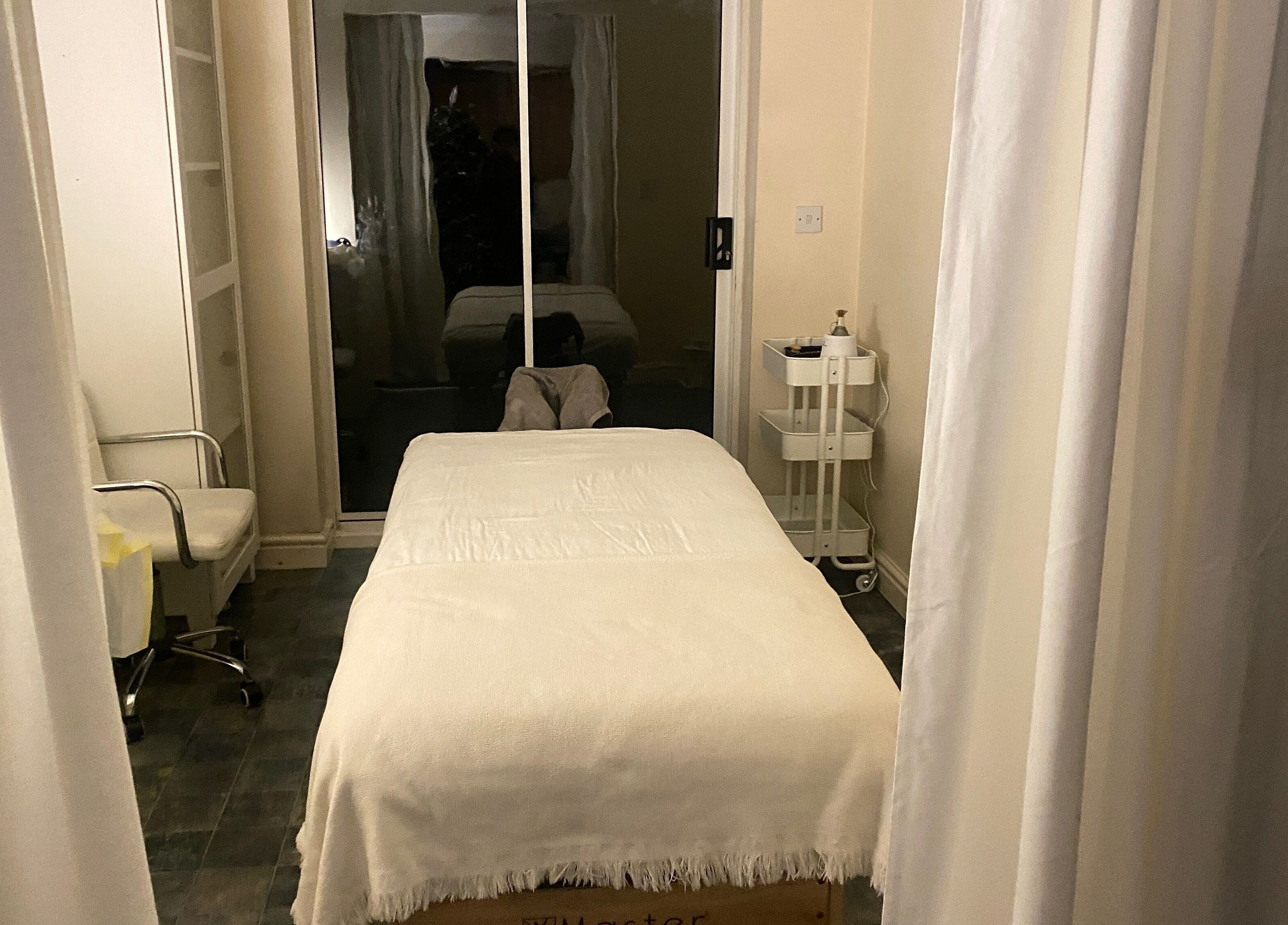 Tranquil massage room at Faye Massage & Wellness, Liverpool, England, GB, featuring a cozy treatment table.
