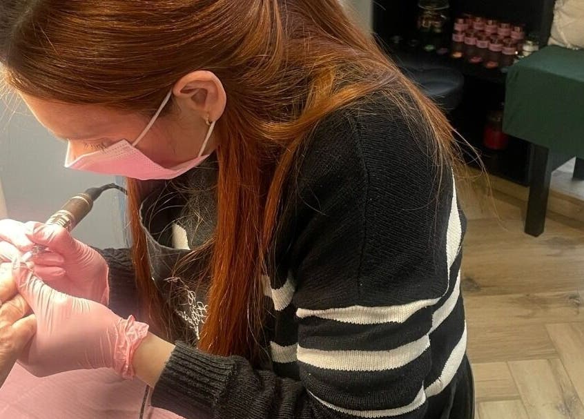 Nail technician performing manicure at The Toni Touch in Bolton, England, GB.