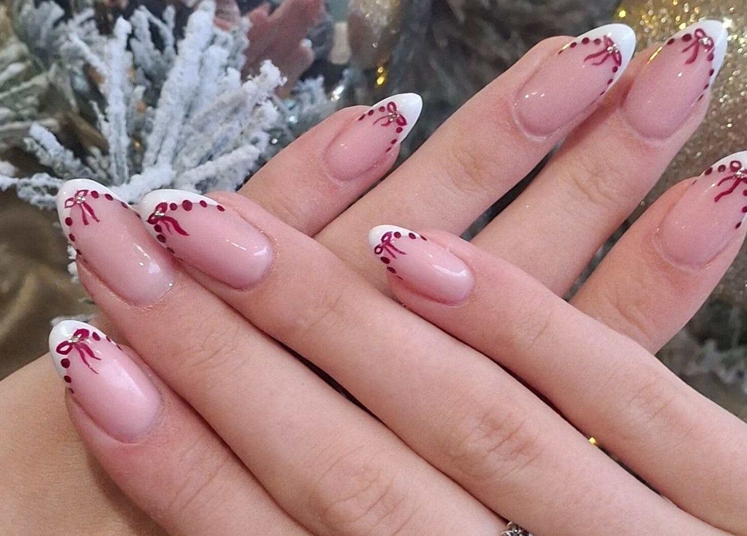 Chic red-accented nails at The Toni Touch, Bolton, England, GB, showcasing intricate festive designs.
